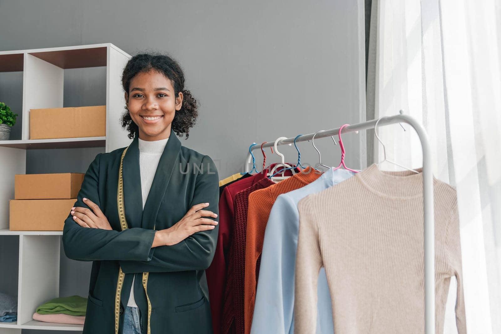 portrait smile black woman working on clothes in tailoring atelier. Attractive beautiful young female fashion designer smile after success in make new handmade suit in workshop...