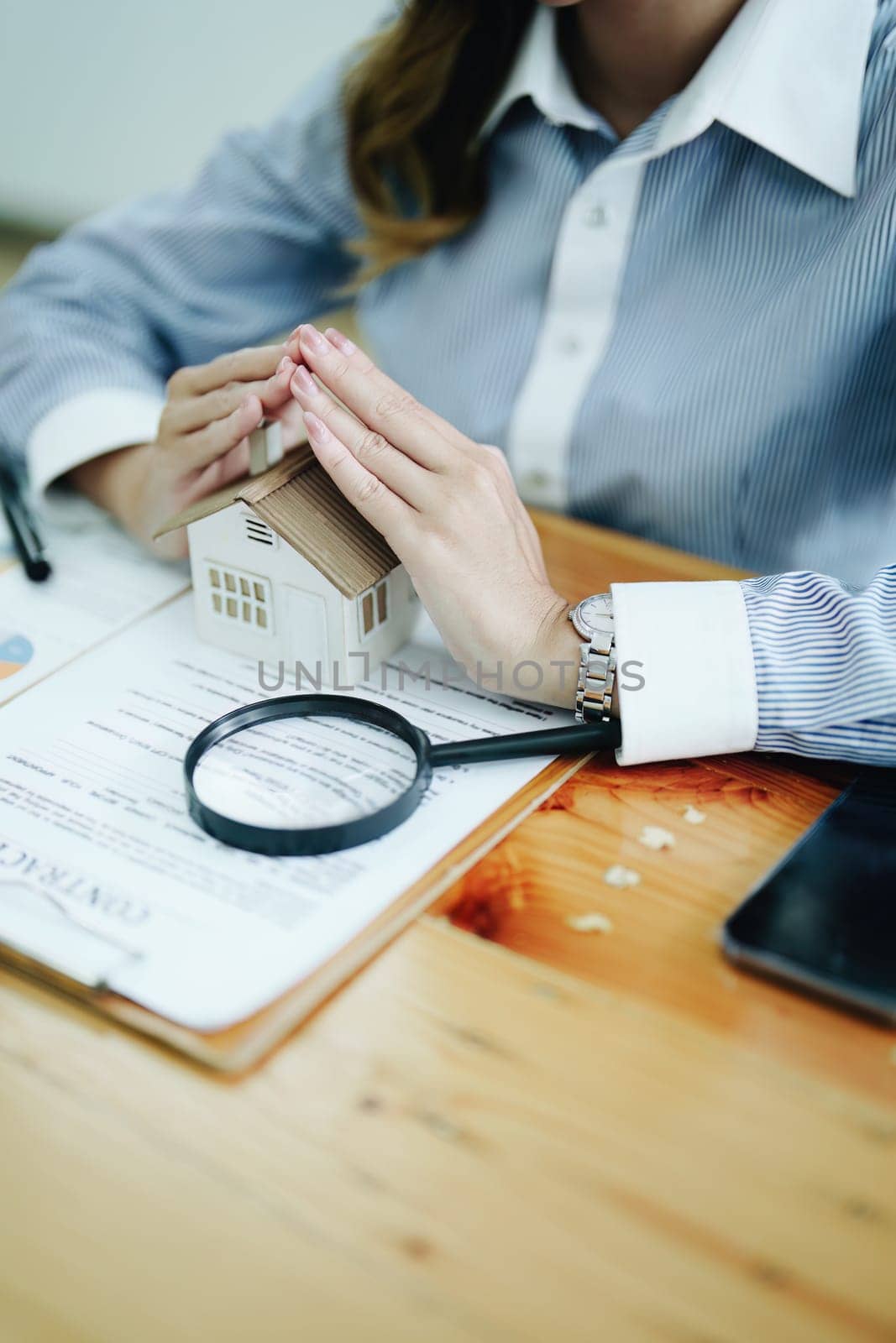 portrait of an asian man, Agent, buy and sell land, property tax, show the concept of protecting the house to insure the risk of damage to the home.