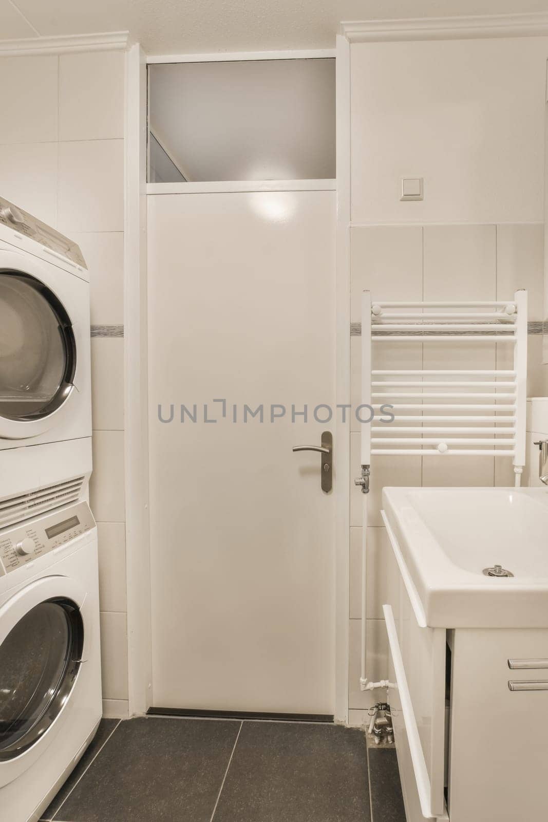 a white laundry room with a washing machine and sink by casamedia