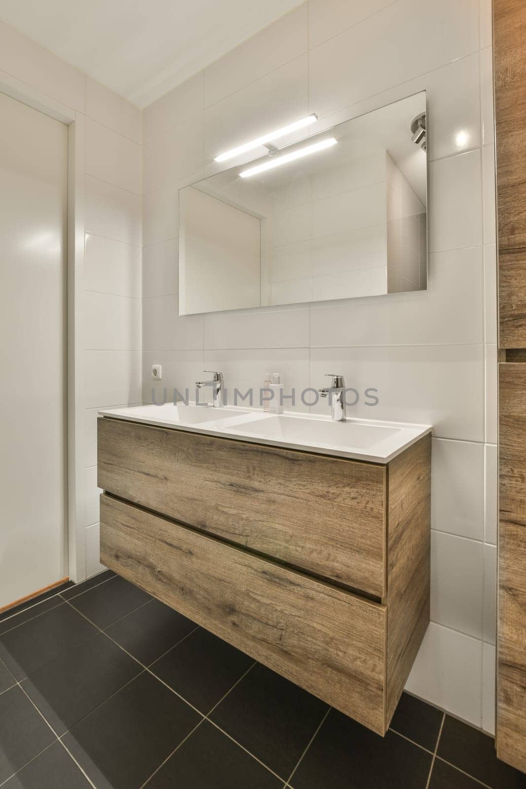 a bathroom with a sink and a mirror by casamedia