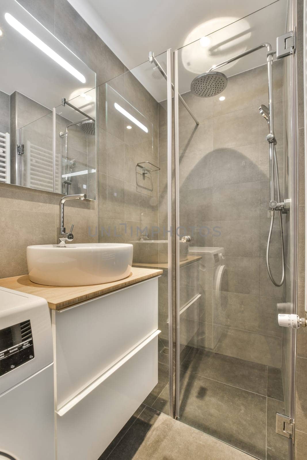 a bathroom with a sink, mirror and shower stall in the corner next to it is a white wash basin