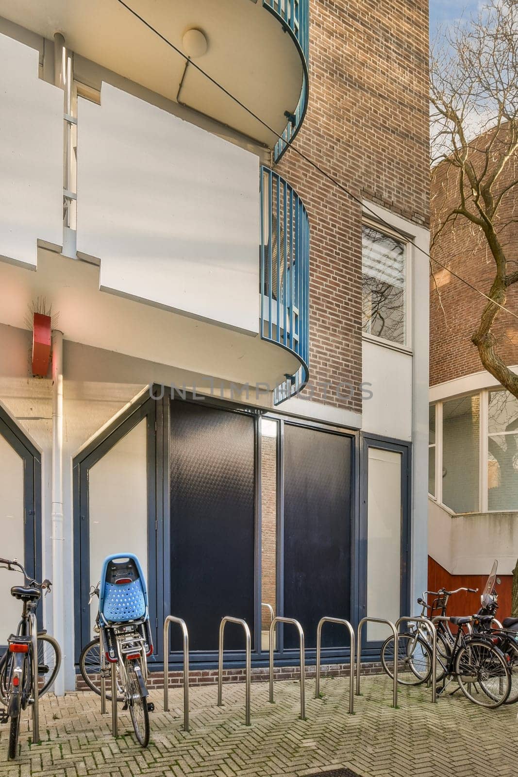 a group of bikes parked in front of a building by casamedia