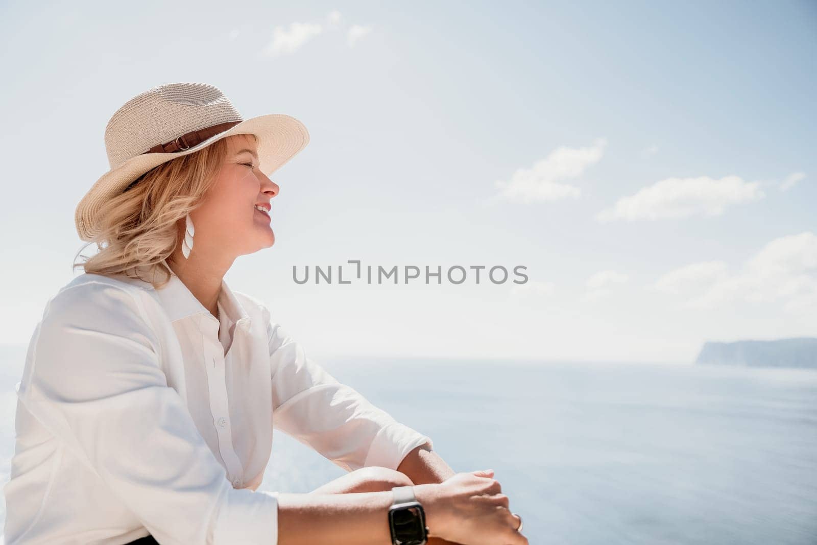 Woman sea laptop. Business woman in yellow hat freelancer with laptop working over blue sea beach. Girl relieves stress from work. Freelance, digital nomad, travel and holidays concept by panophotograph