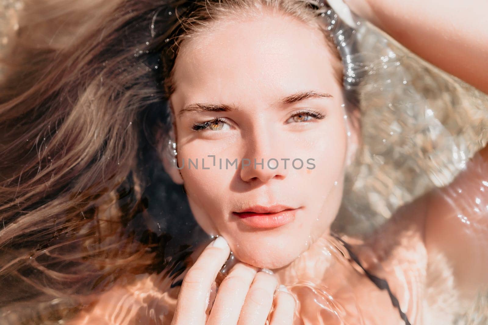 Woman travel sea. Young Happy woman in a long red dress posing on a beach near the sea on background of volcanic rocks, like in Iceland, sharing travel adventure journey