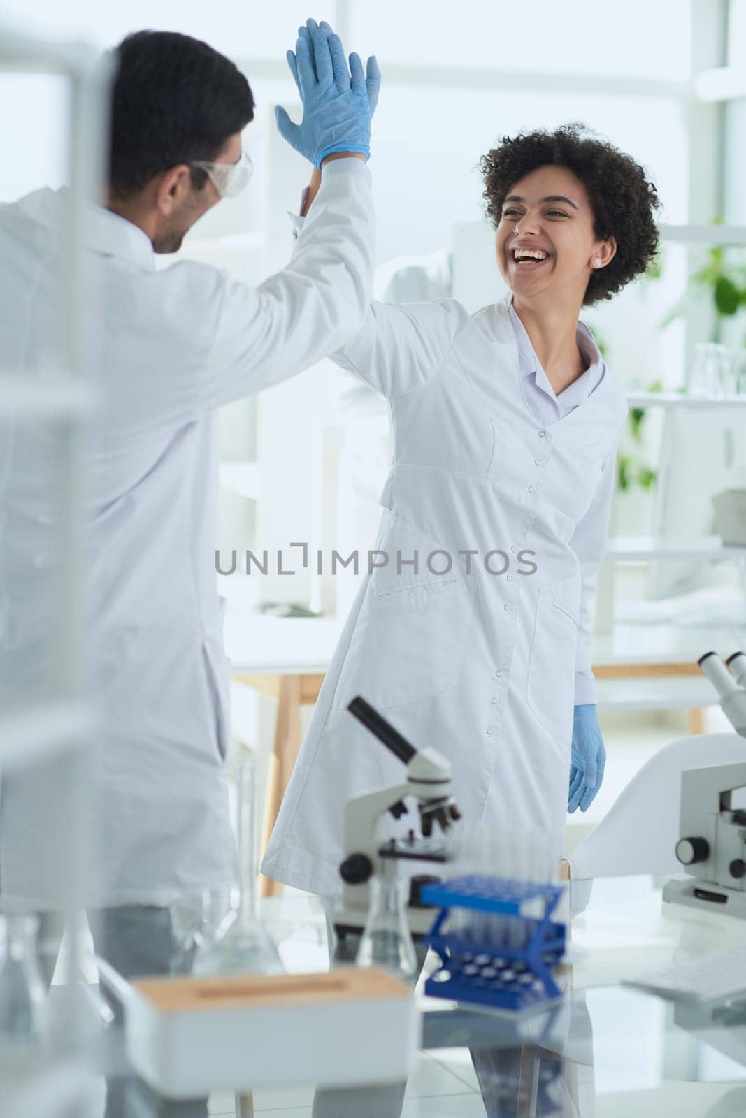 Team of Scientists Working Using Microscope, Analysing Microbiology Samples