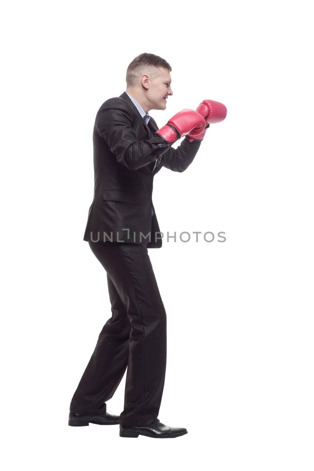 in full growth. young businessman in Boxing gloves. isolated on a white background.