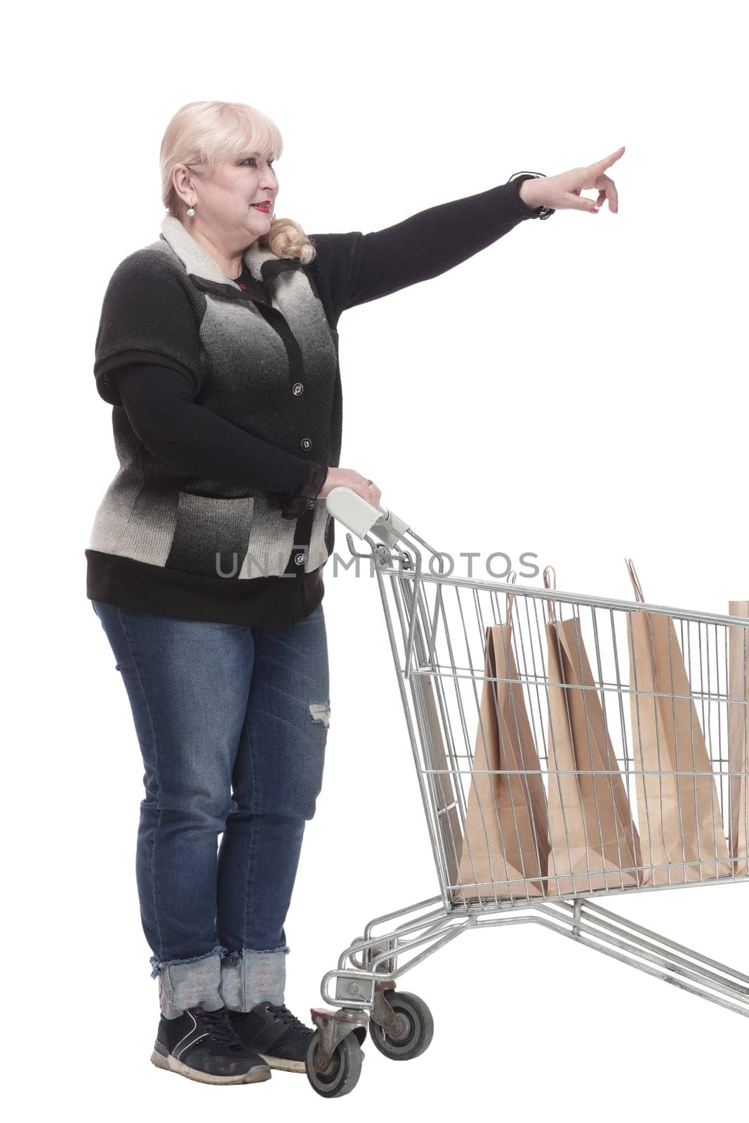 full-length. casual woman in jeans with shopping cart. isolated on a white background.