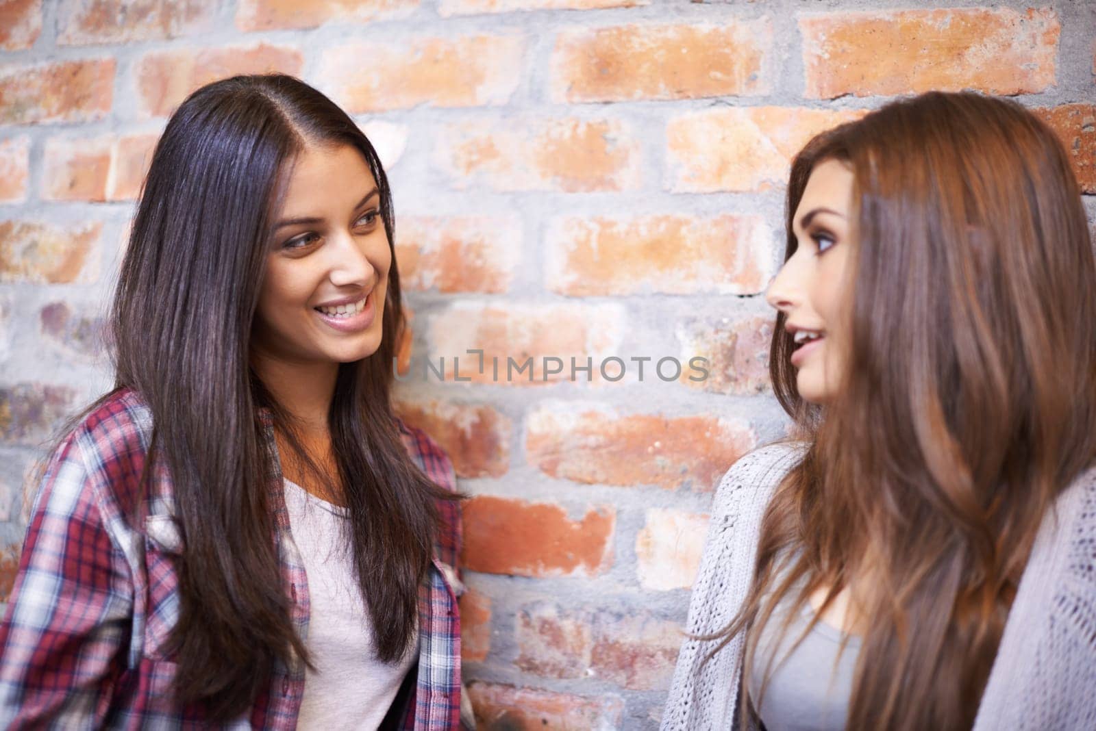Education always puts a smile on my face. two female university students talking in the hallway