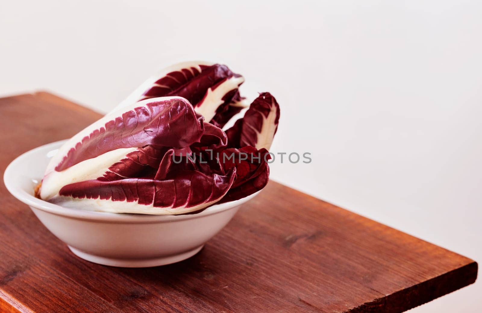 Radicchio, red  leaves chicory, italian chicory in white bowl , common use in Italian cuisine