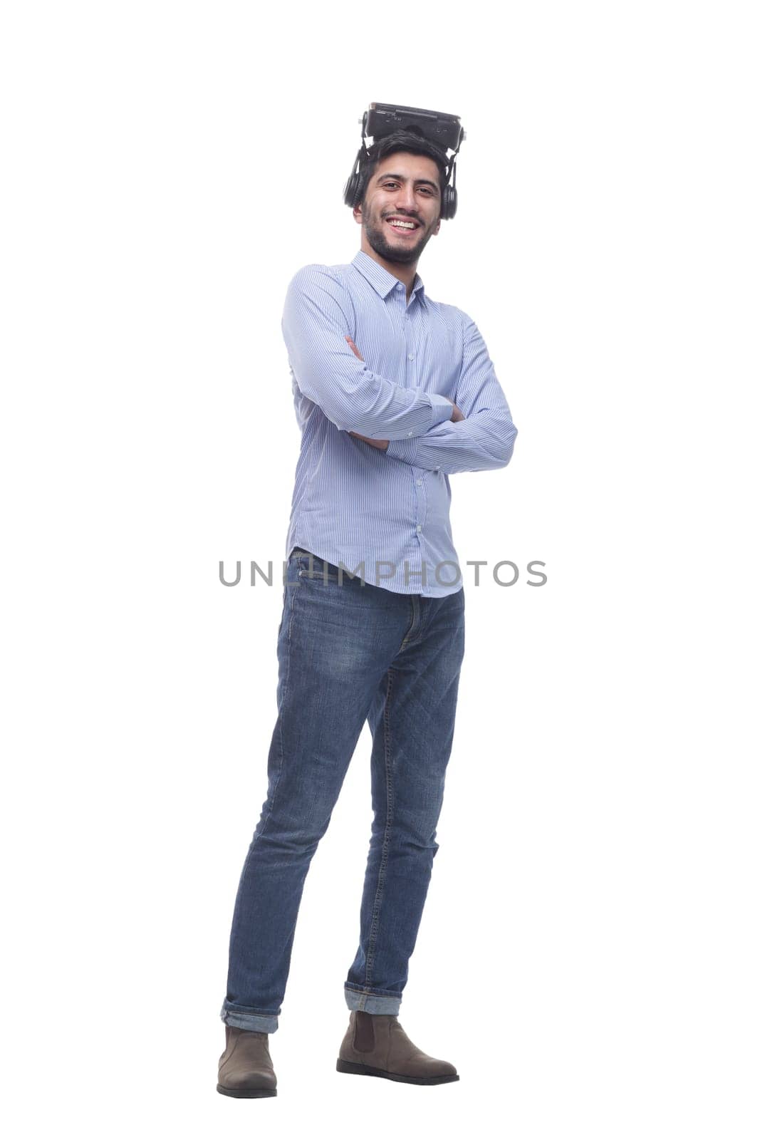 in full growth. confident young man in virtual reality glasses. isolated on a white background.