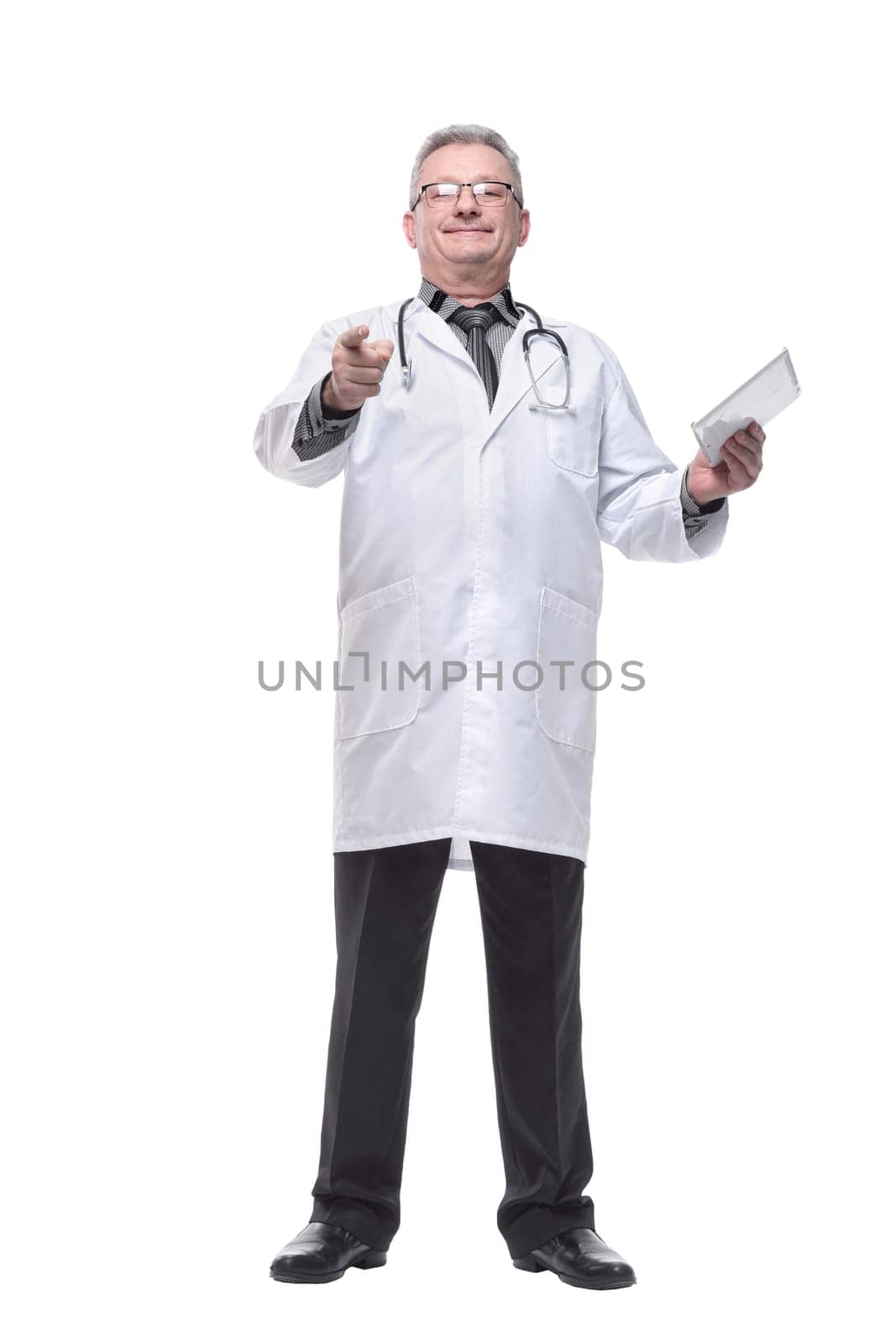 Senior doctor wearing tie and glasses using his tablet computer at work