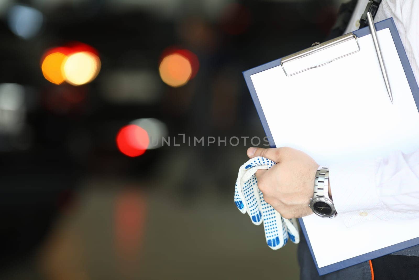 Auto mechanic and auto engineer technician holding clipboard blank sheet with copy space for car repair checklist by kuprevich