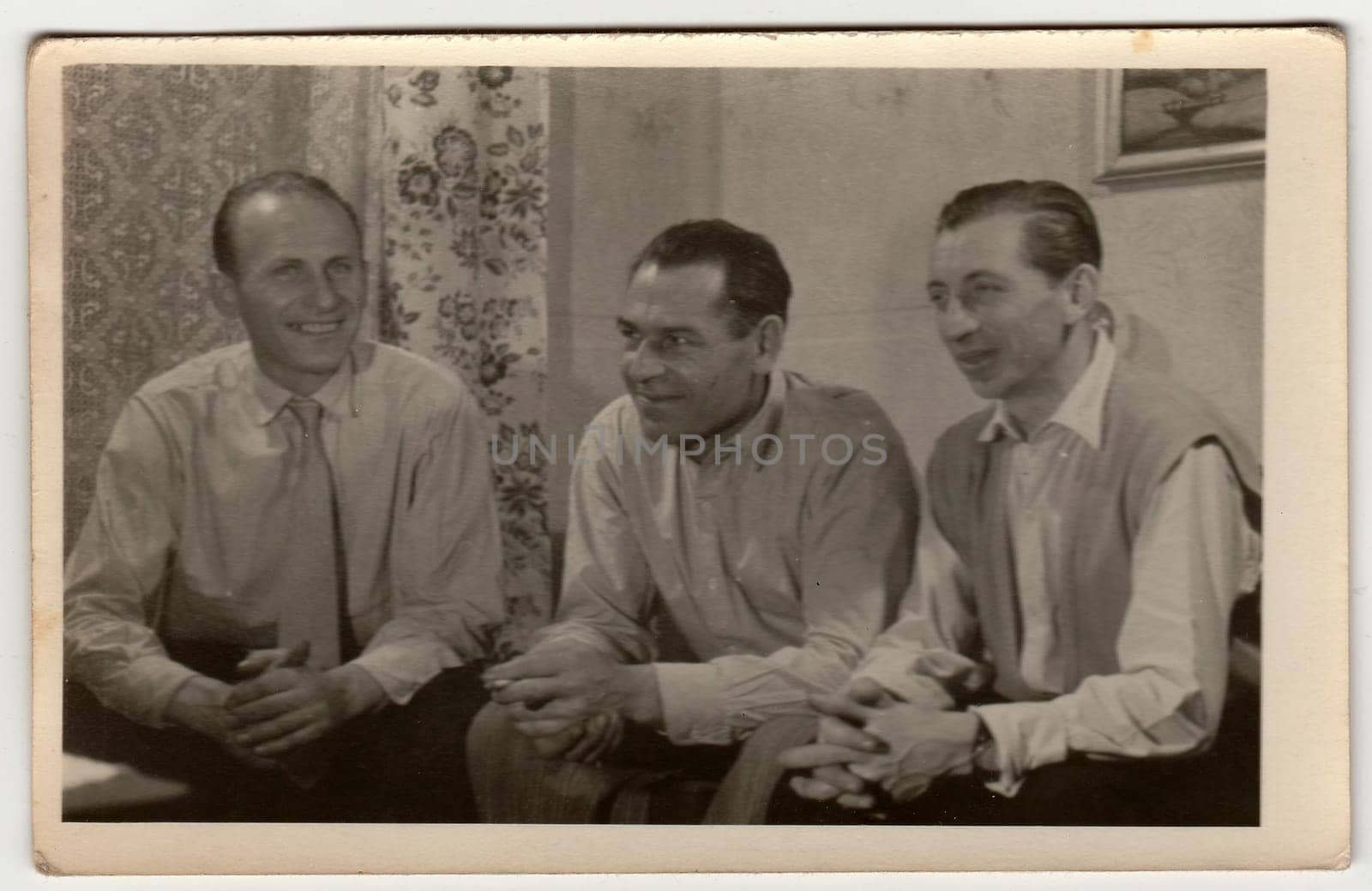 Vintage photo shows men have a pleasant time at home. by roman_nerud