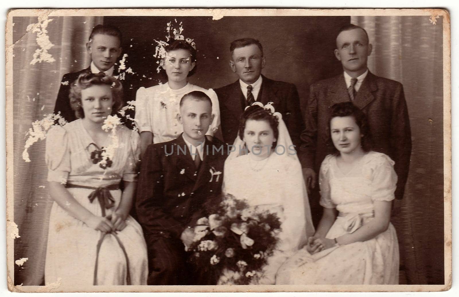 Vintage photo shows newlyweds and wedding guests. by roman_nerud