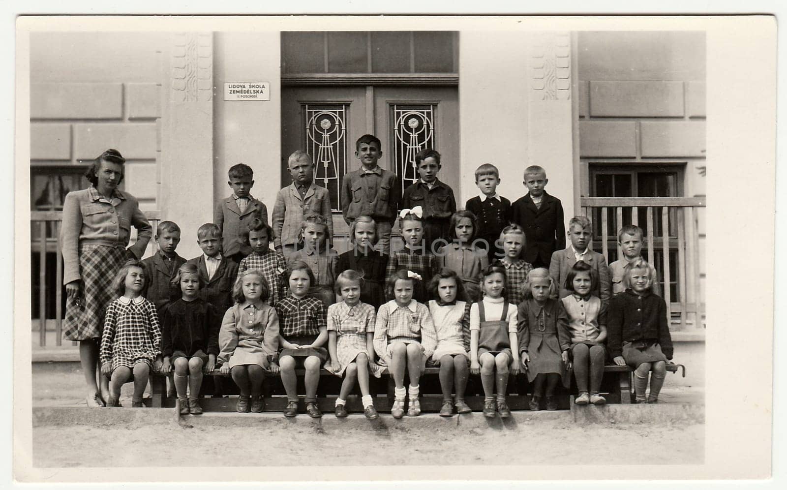 THE CZECHOSLOVAK SOCIALIST REPUBLIC - CIRCA 1948: Vintage photo shows pupils (schoolmates) and their female teacher.