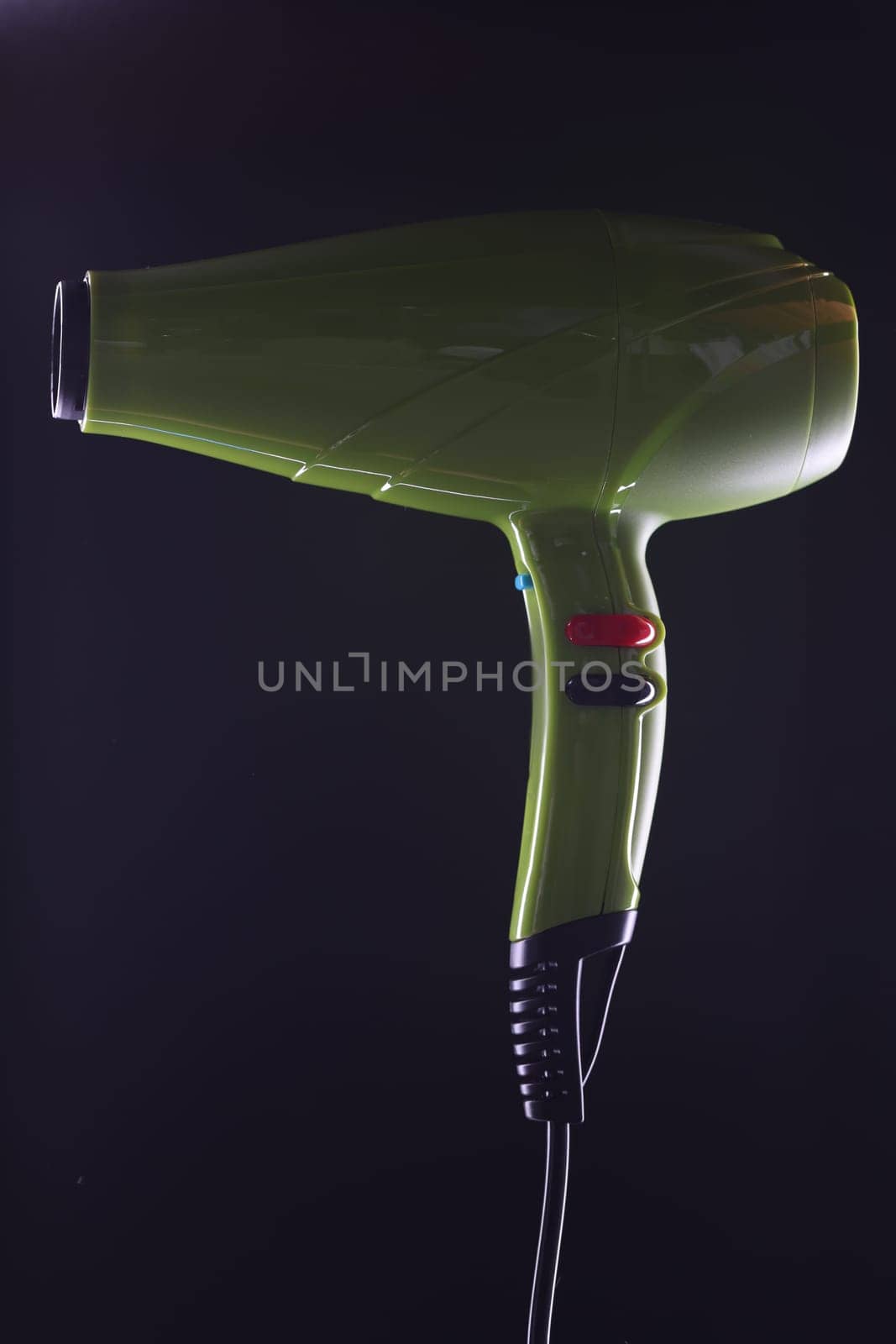 Green modern stylish hair dryer on black background by kuprevich