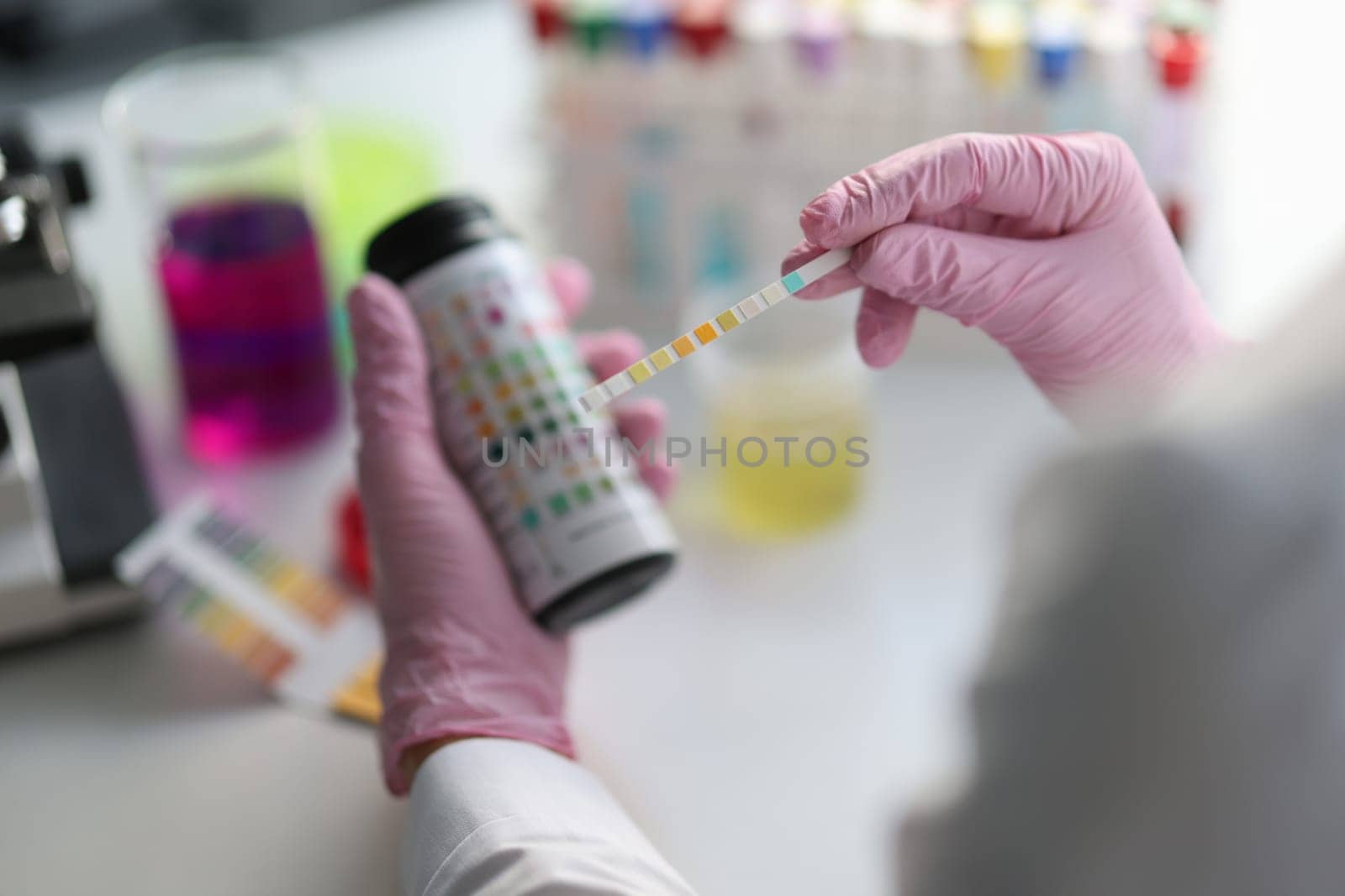 Chemist scientist holding ph test in hands closeup by kuprevich