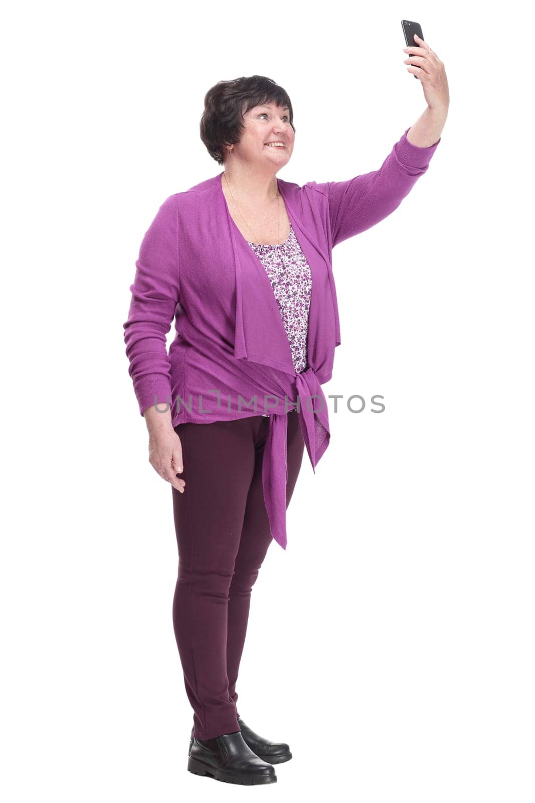 in full growth.casual an elderly woman with a smartphone. isolated on a white background.