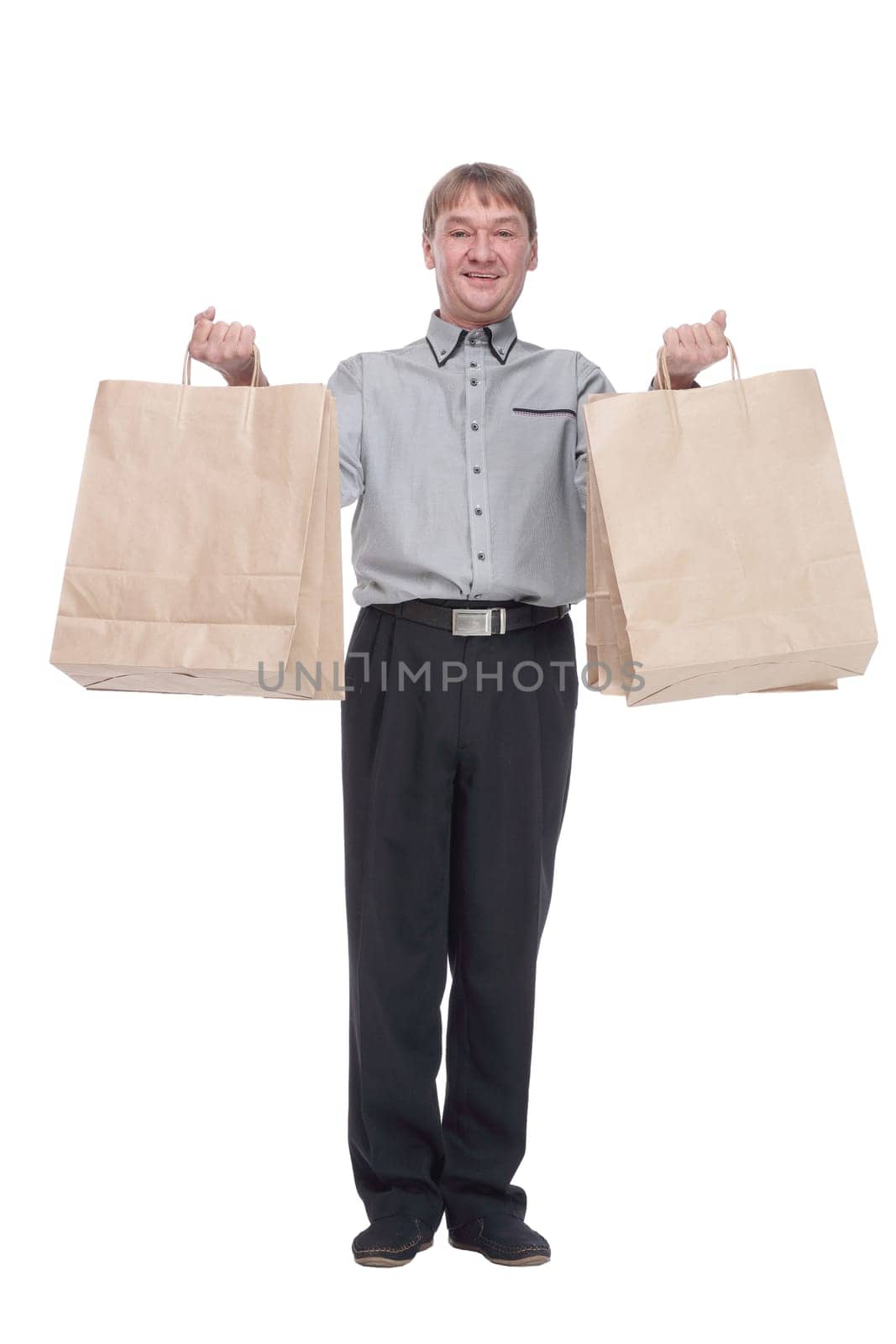 in full growth.senior man with shopping bags . isolated on a white background.