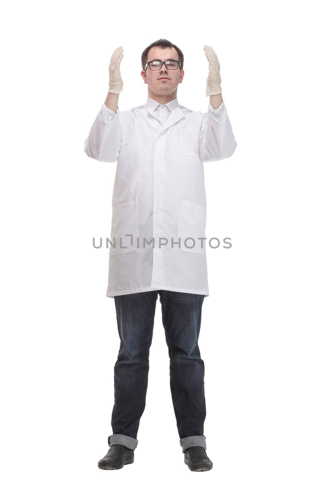 Cheerful male doctor in a white coat in gloves shows thumb up and holding the beaker