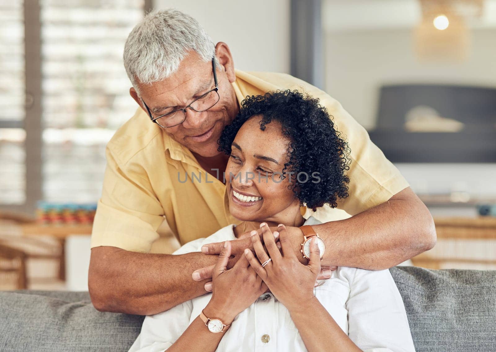 Love, relax and senior couple hug, care and enjoy quality bonding time on home living room sofa. Retirement happiness, marriage smile and romantic elderly husband, wife or people happy together.