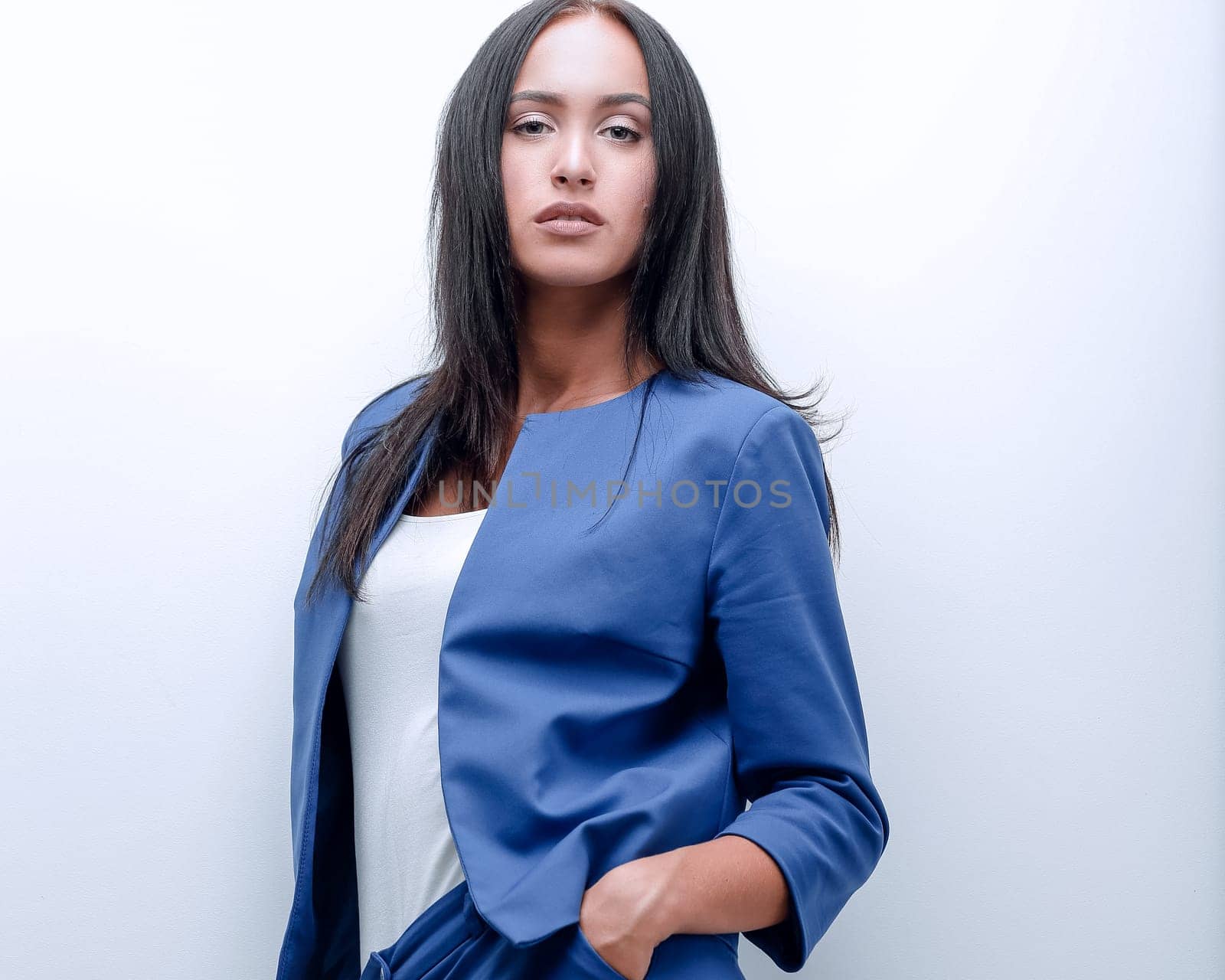 Portrait of a female with a serious face, woman in a jacket and shirt on a white background