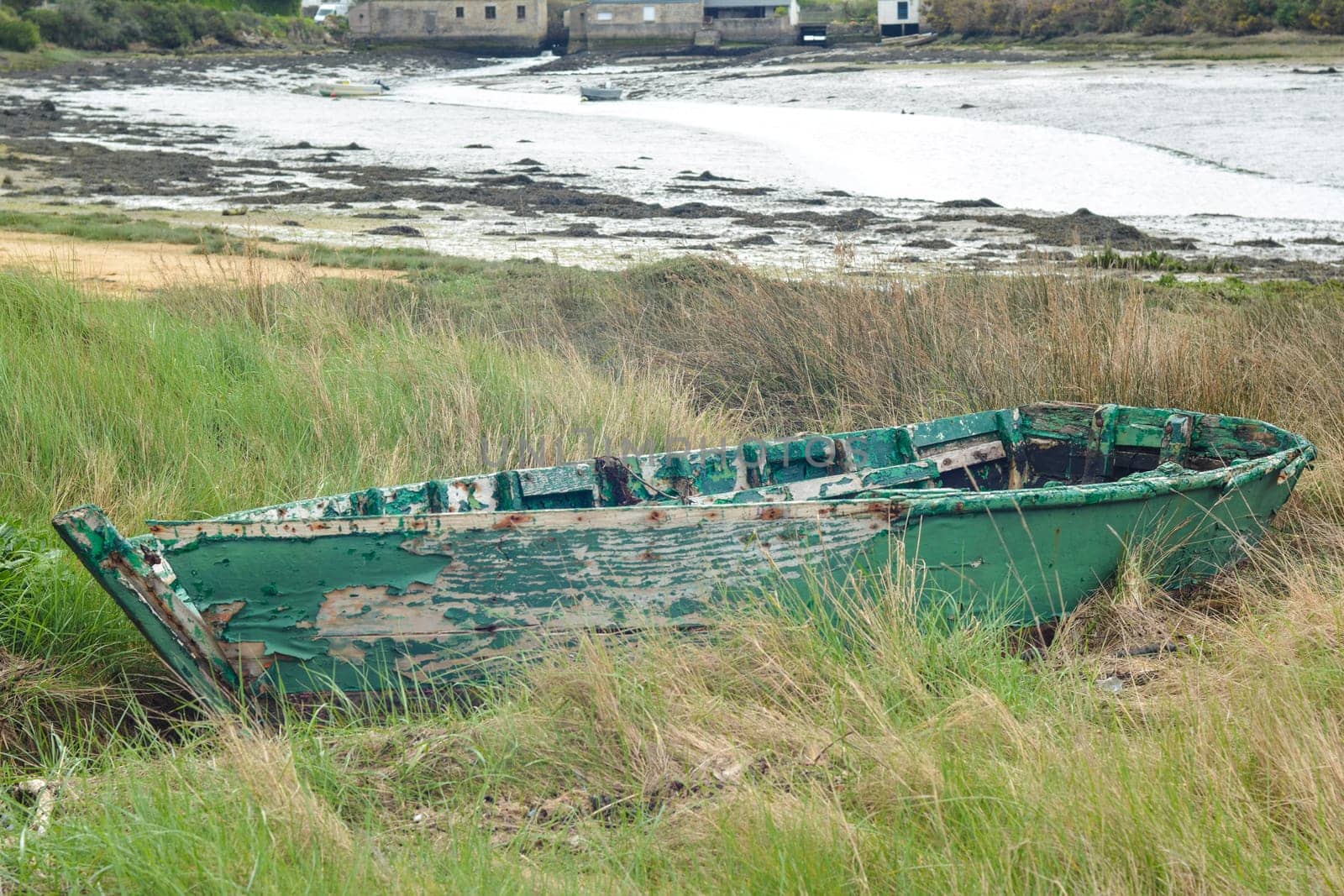 Green abandoned boat in the Atlantic Ocean
