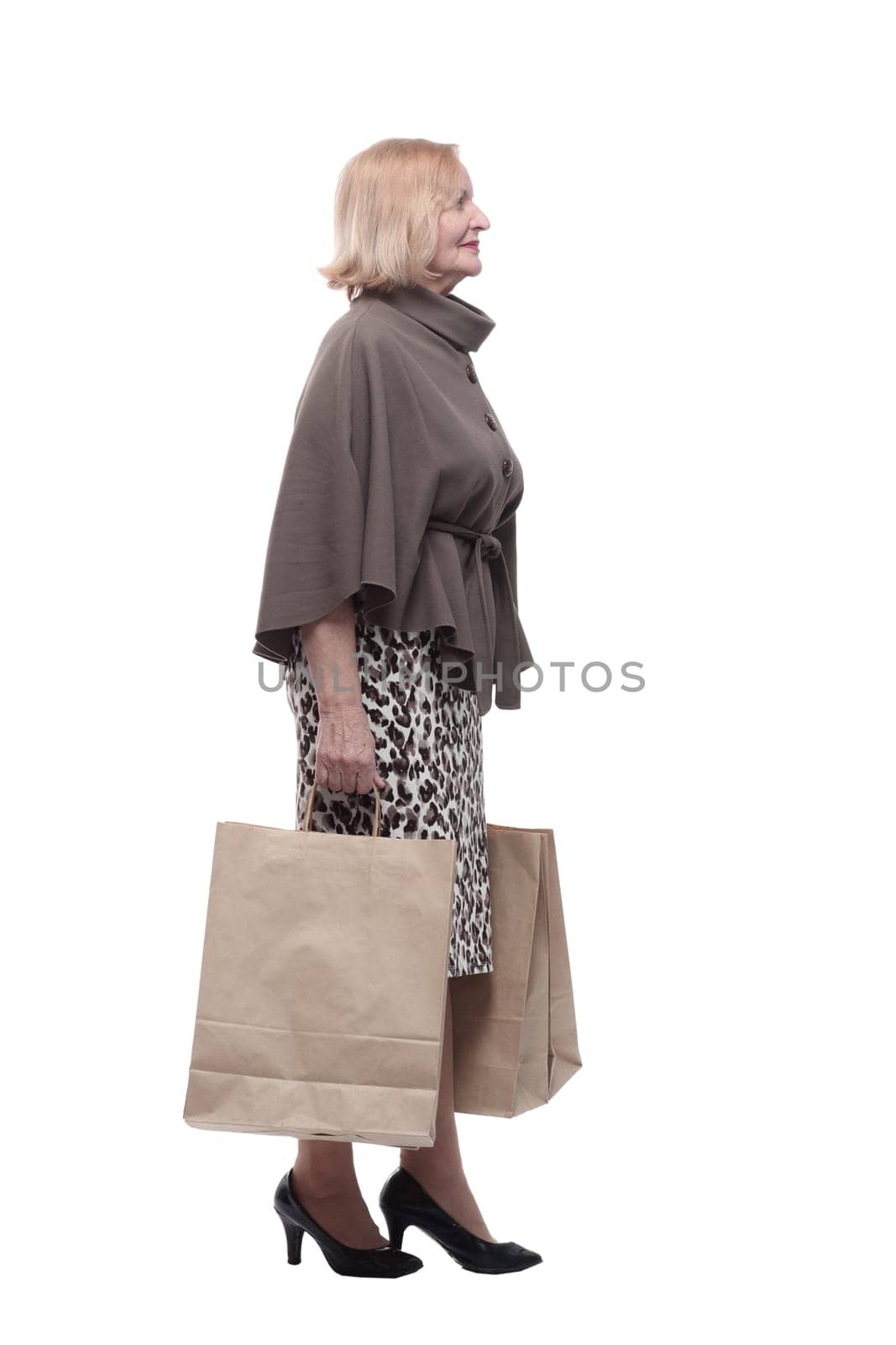 attractive mature woman with shopping bags . isolated on a white background.