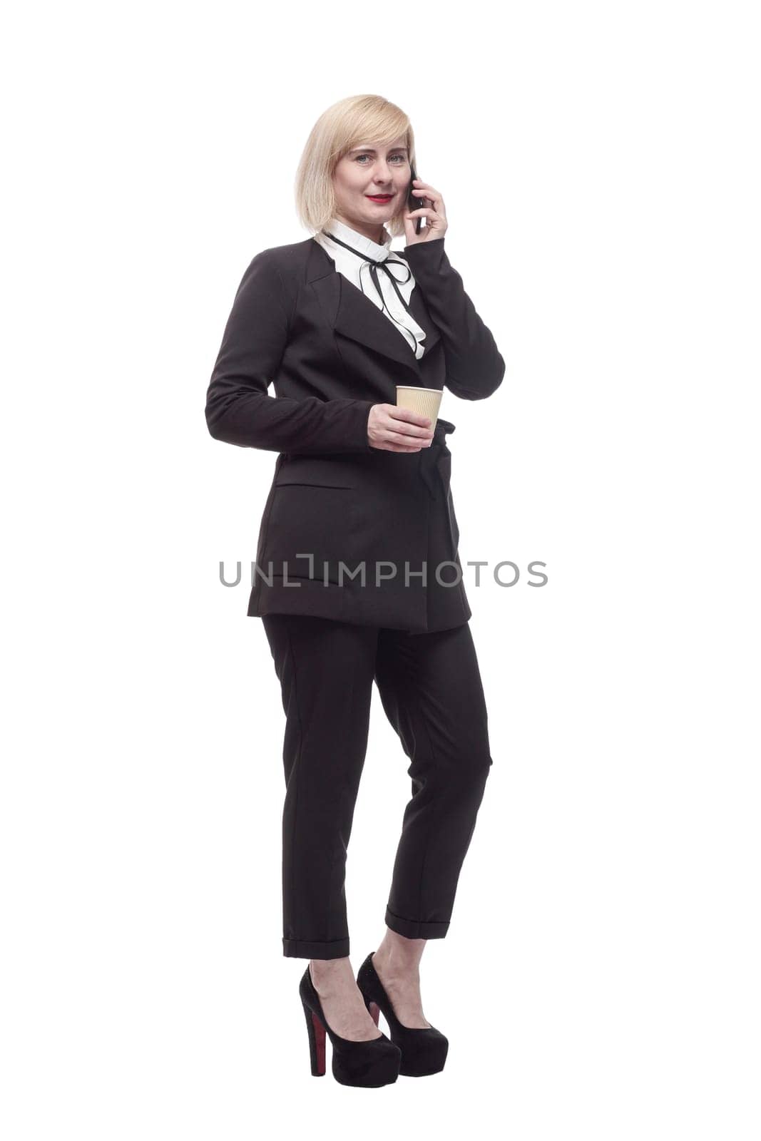 in full growth. business woman with a smartphone and takeaway coffee. isolated on a white background.