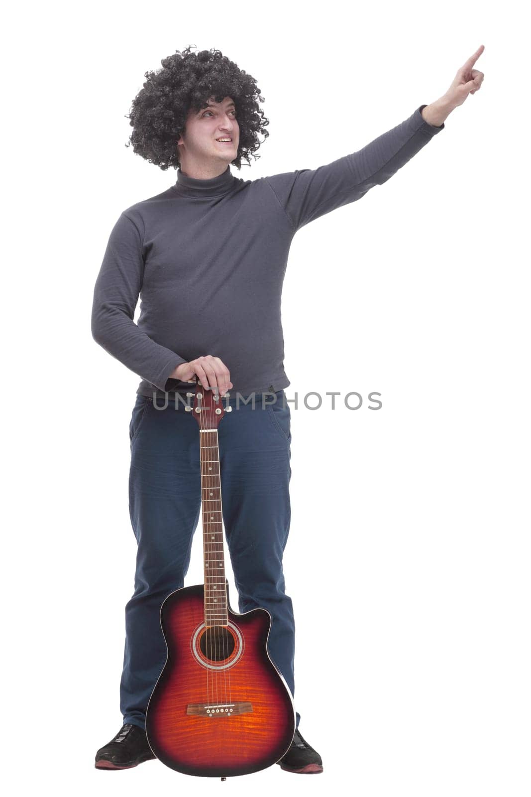 in full growth. curly-haired cheerful man with a guitar. isolated on a white background.