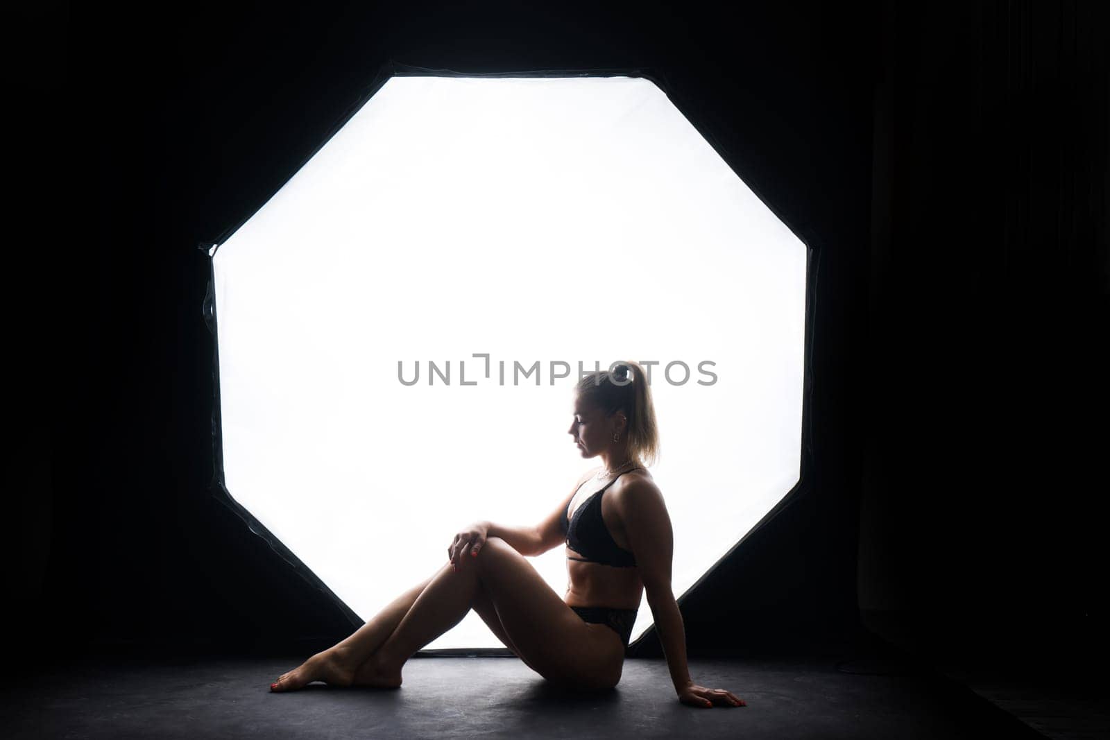 Silhouette of a beautiful young woman wearing underwear in backlight by Zelenin