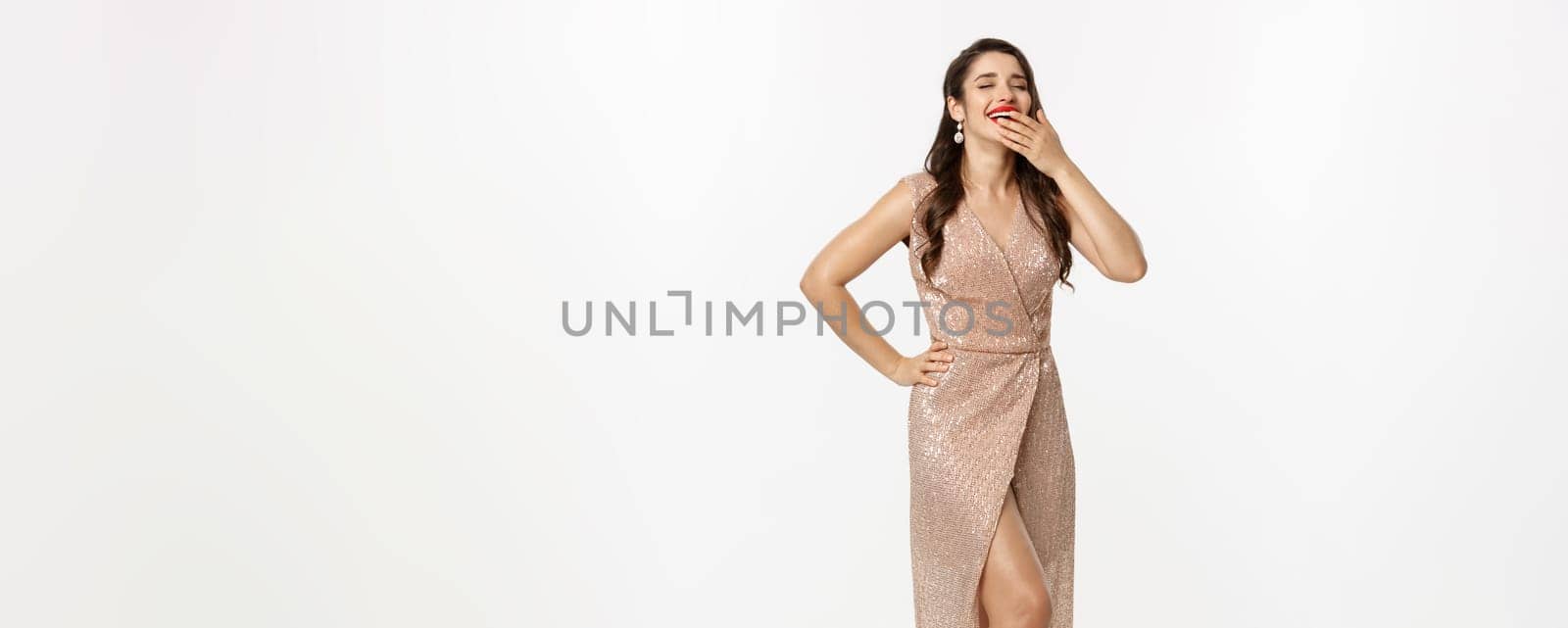 Christmas party and celebration concept. Full length of glamour woman in elegant dress, laughing and looking happy, having fun, white background.