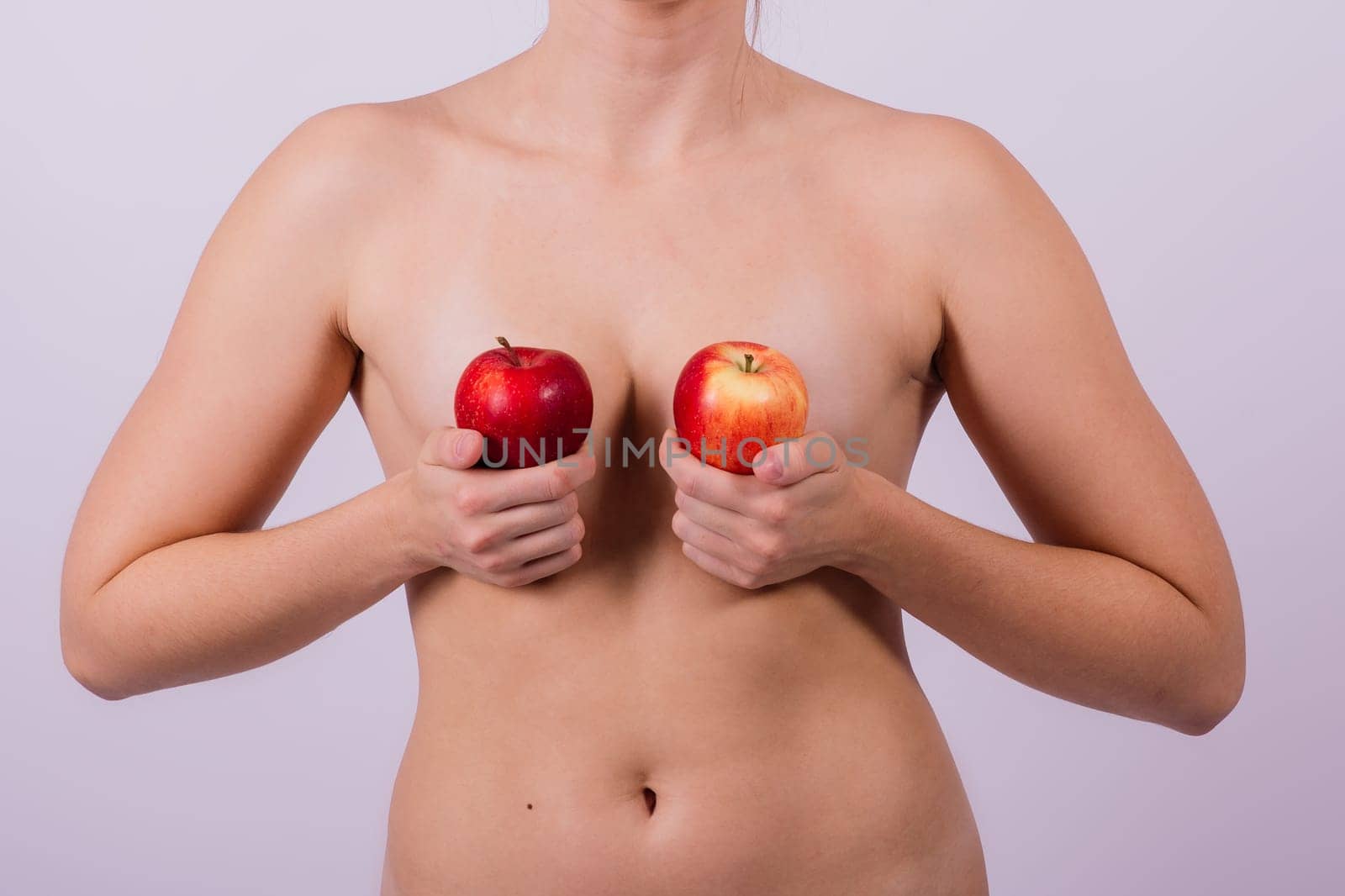 Beautiful naked woman with apples looking at camera, with open hands by Zelenin