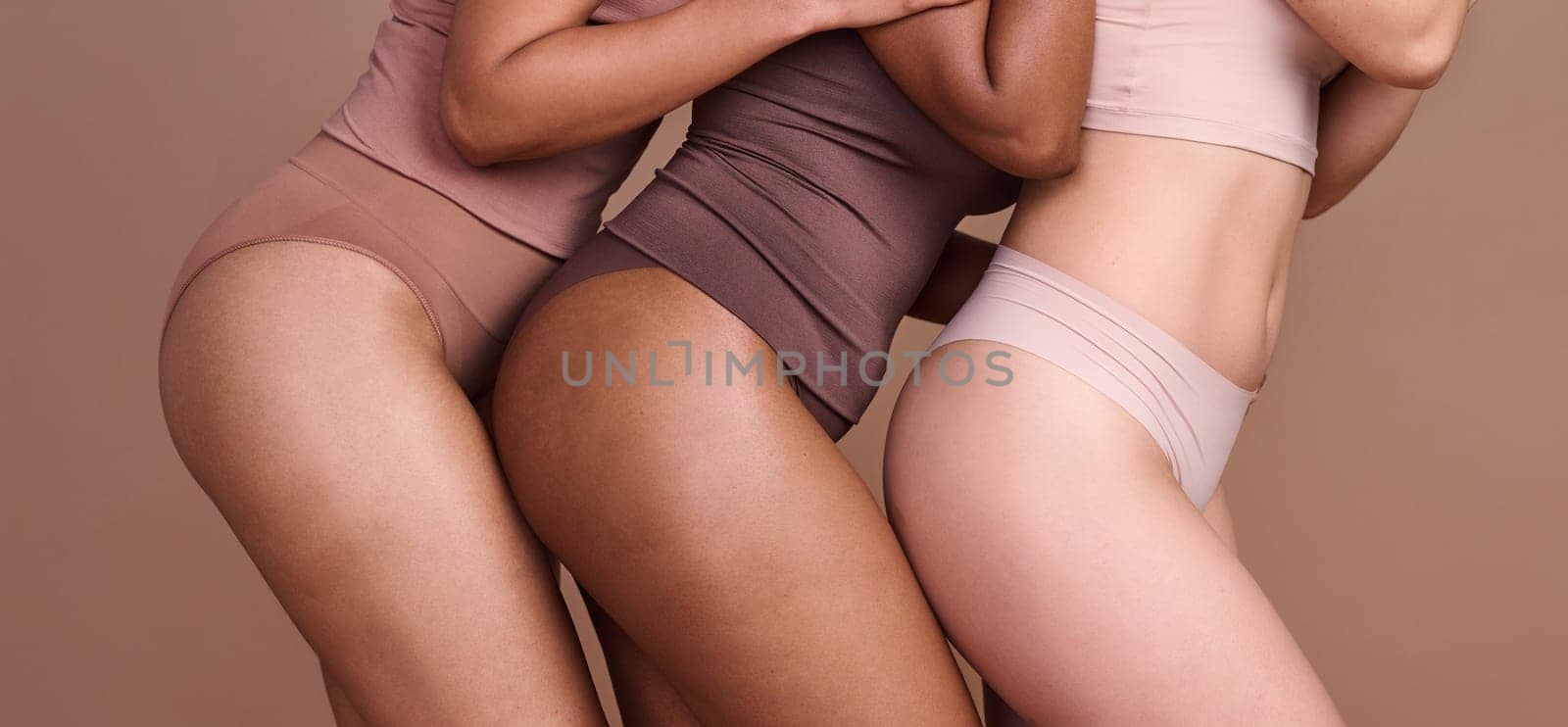 Legs, skincare and diversity of body positive women, natural beauty and wellness on studio. Group, models and thighs together in underwear for laser cosmetics, healthy glow or aesthetics of self care by YuriArcurs