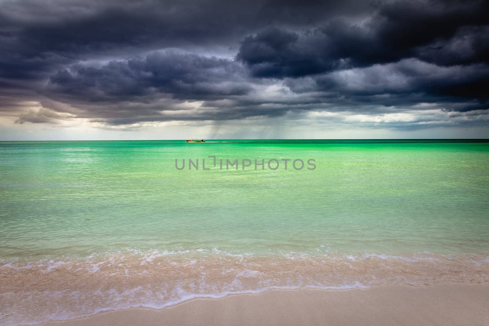 Tropical caribbean beach with storm clouds in idyllic Montego Bay, Jamaica