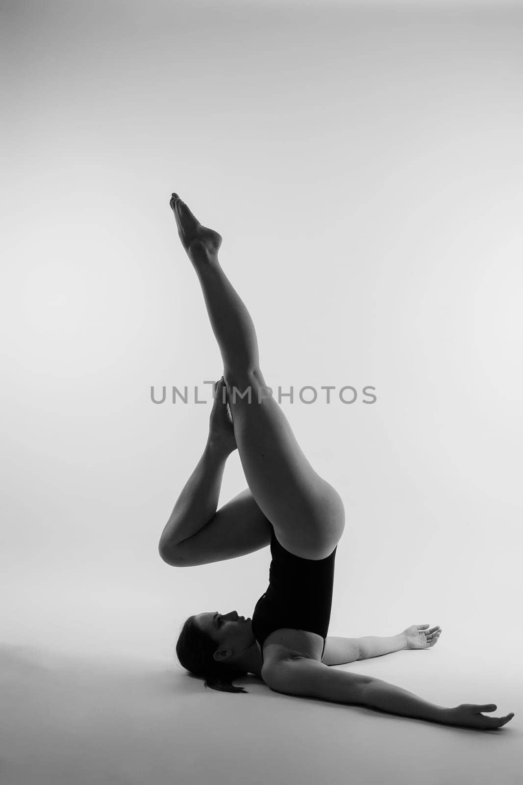 Athletic woman in swimsuit, doing yoga, push-ups, beautiful female exercising at studio by Zelenin
