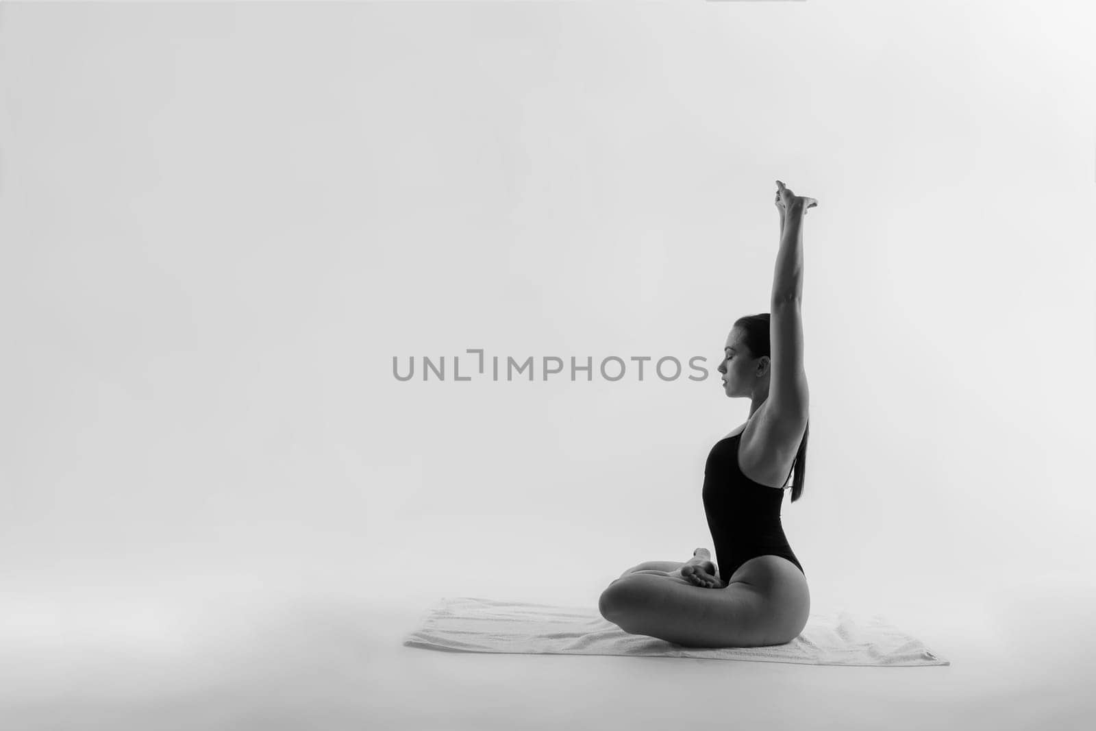 Athletic woman in swimsuit, doing yoga, push-ups, beautiful female exercising at a studio