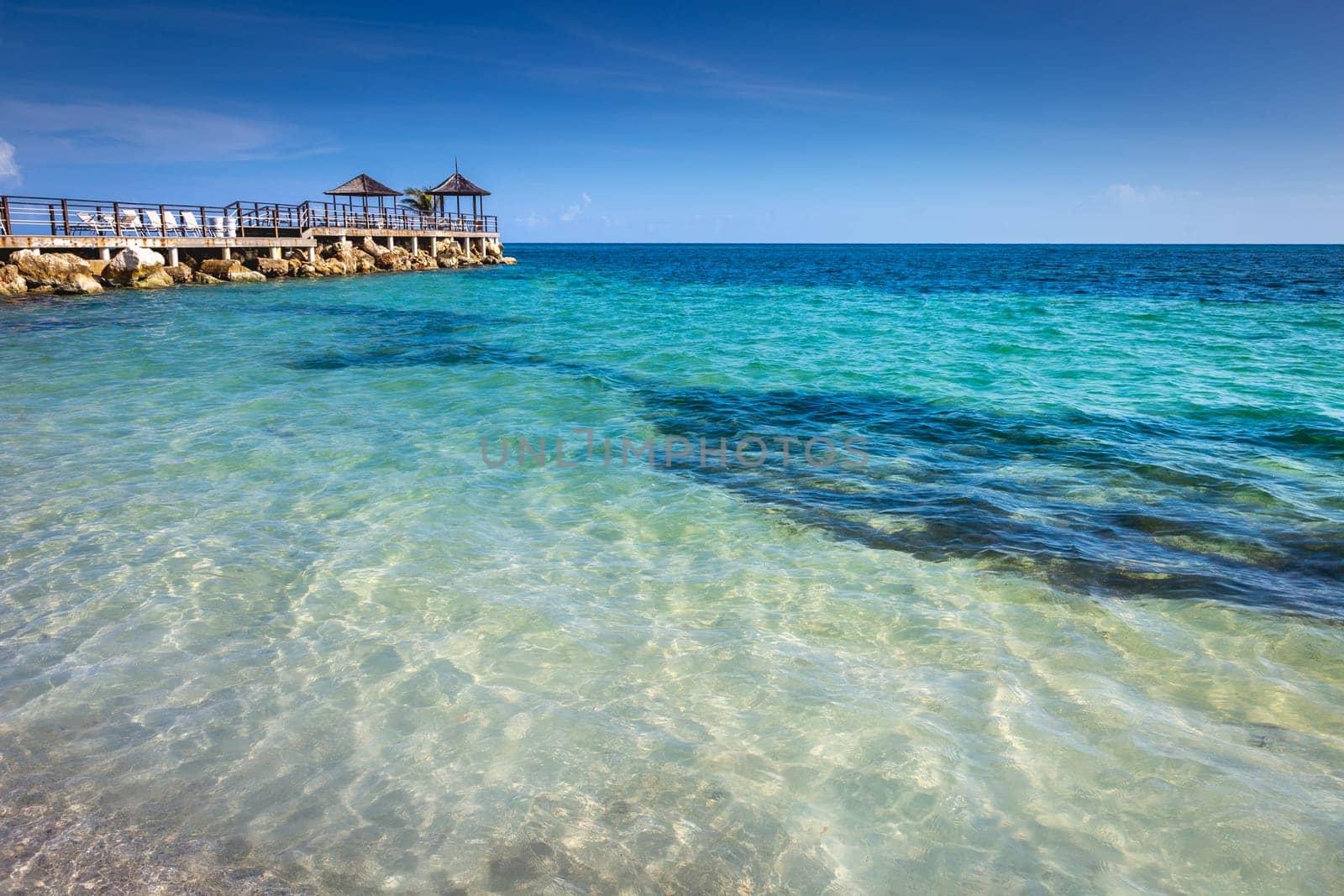 Tropical caribbean beach with turquoise waters in idyllic Montego Bay, Jamaica