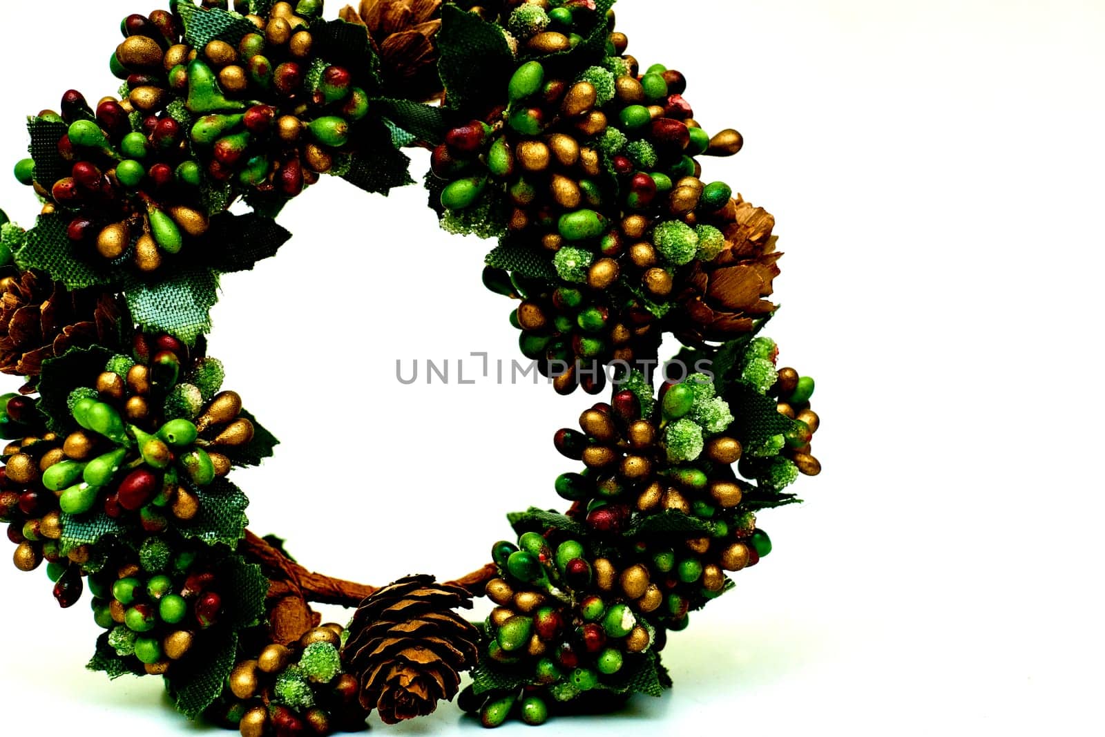 Artificial green brown wreath with leaves cones berries isolated on white by jovani68