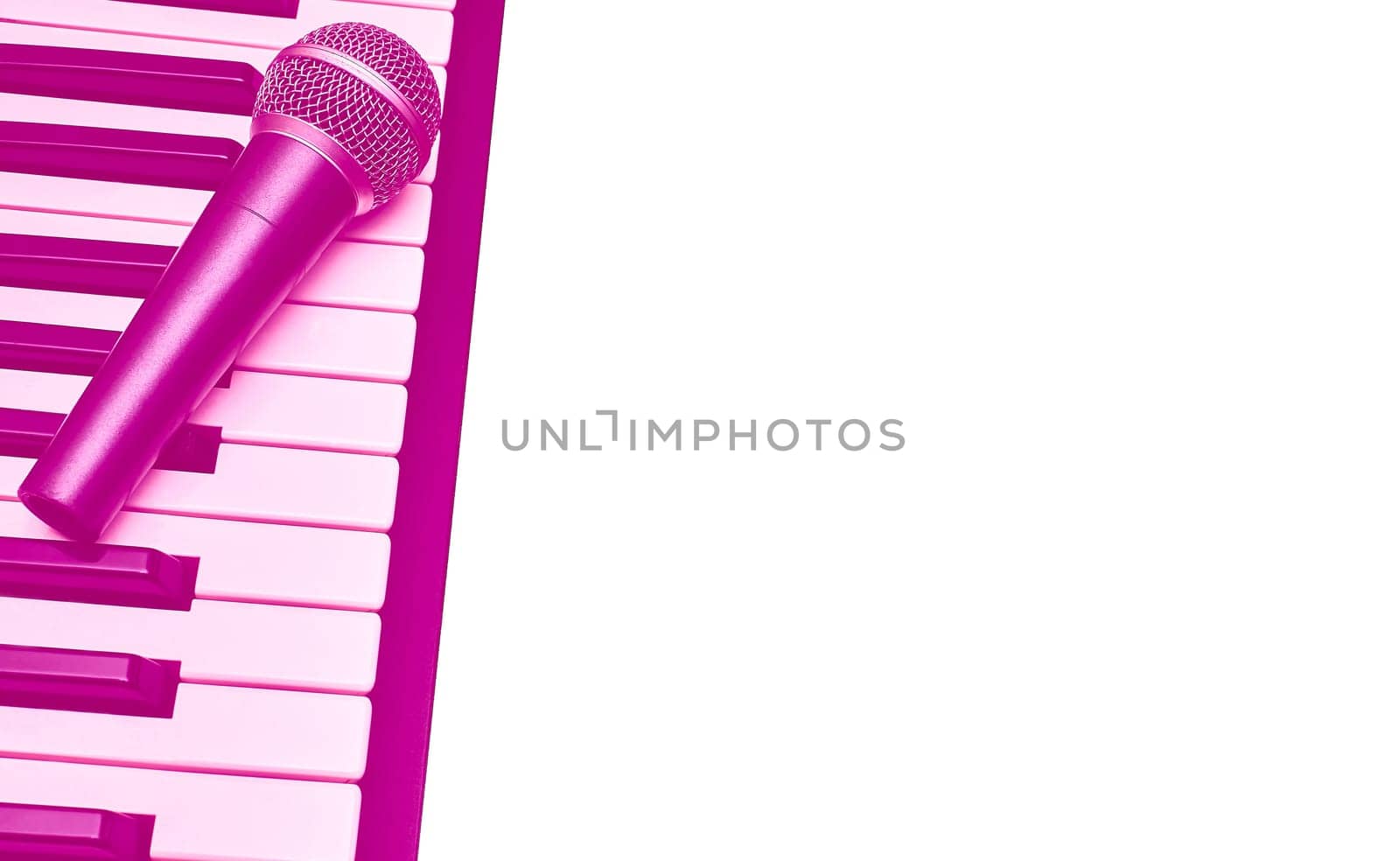 Vocal microphone for singing karaoke on piano synth keys in pink magenta,isolate by jovani68