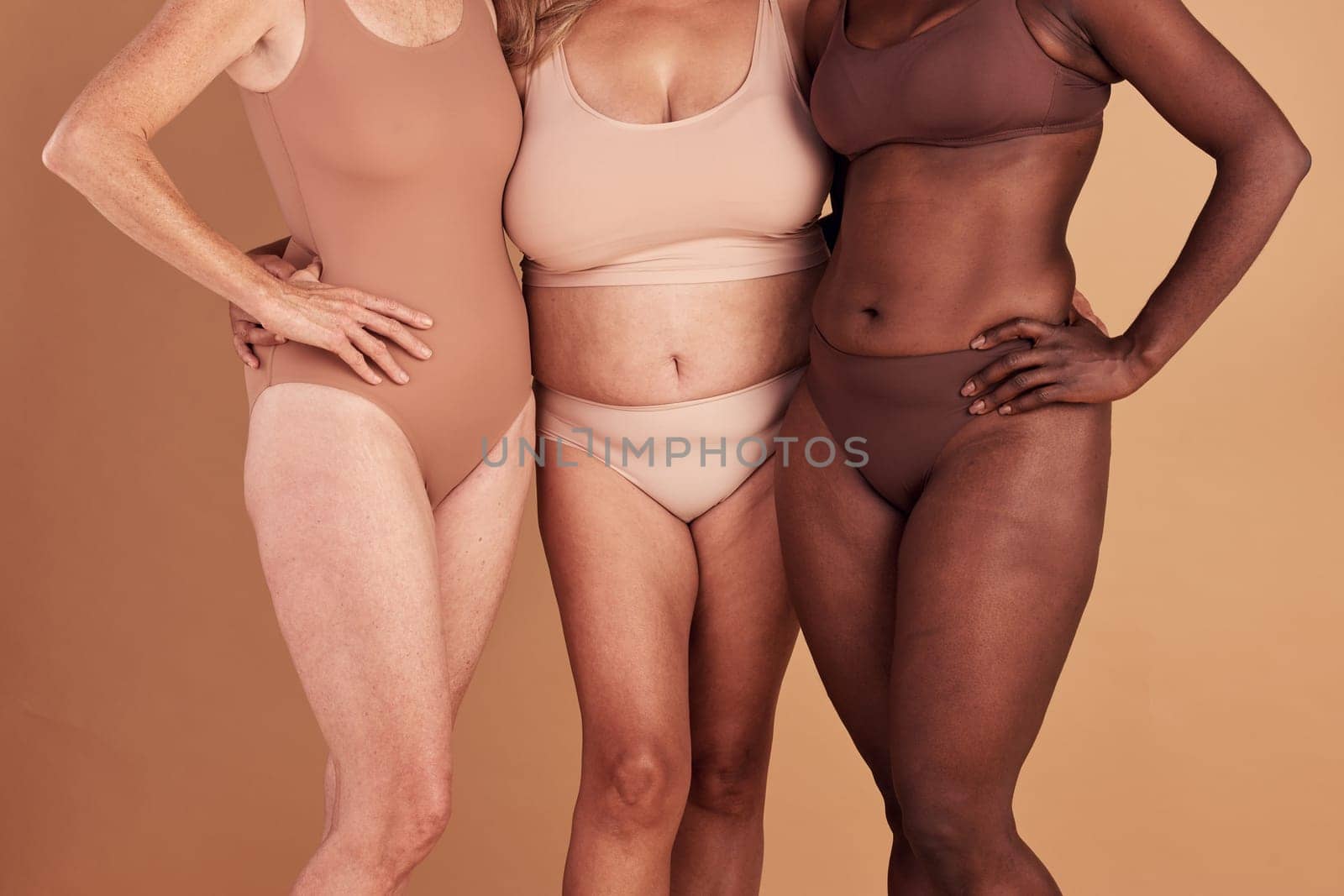 Diversity, closeup or women with body positivity, wellness or support on brown studio background. Multiracial, females or ladies with solidarity, skincare or confident for natural beauty or community by YuriArcurs