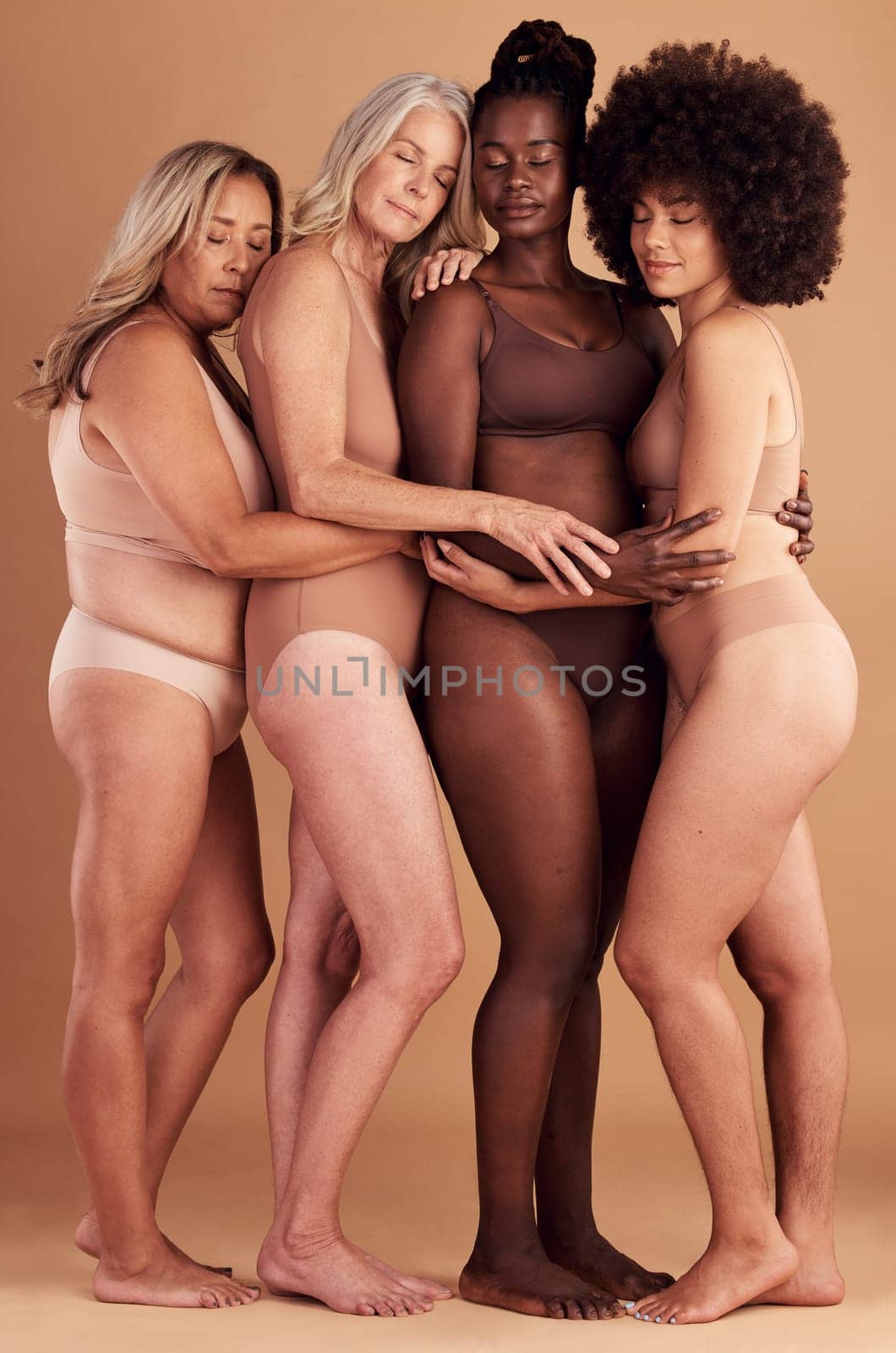 Beauty, diversity hug and body positive women, girl or friends happy together in solidarity, self love and support. Self care, lingerie and woman empowerment group of people embrace for acceptance.