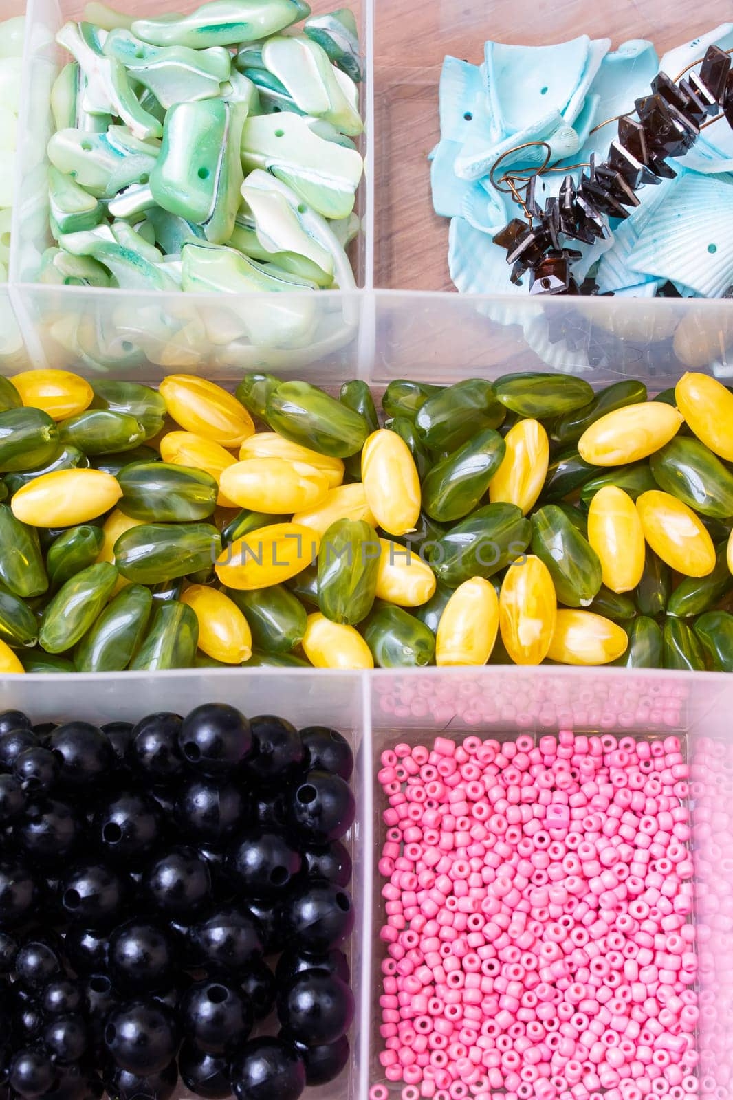Colorful beads in containers close up, handicrafts, macrophoto