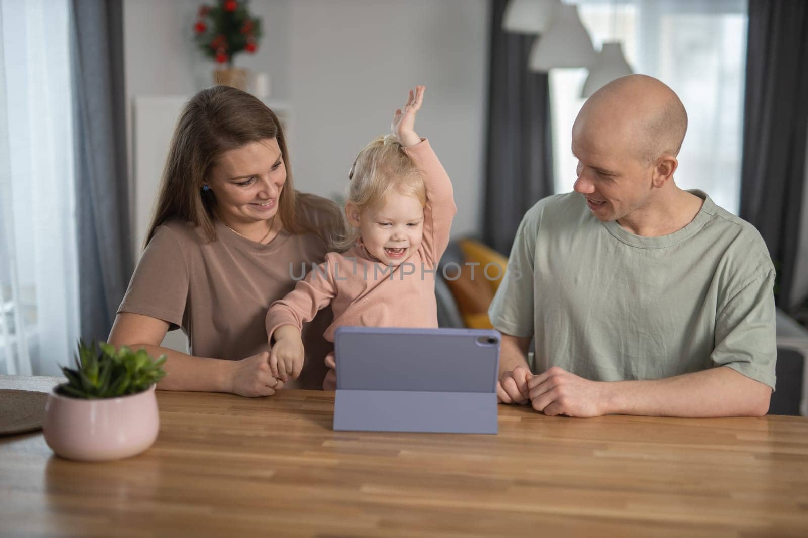 Deaf child girl with cochlear implant studying to hear sounds and have fun with mother and father - recovery after cochlear Implant surgery and rehabilitation concept by Satura86