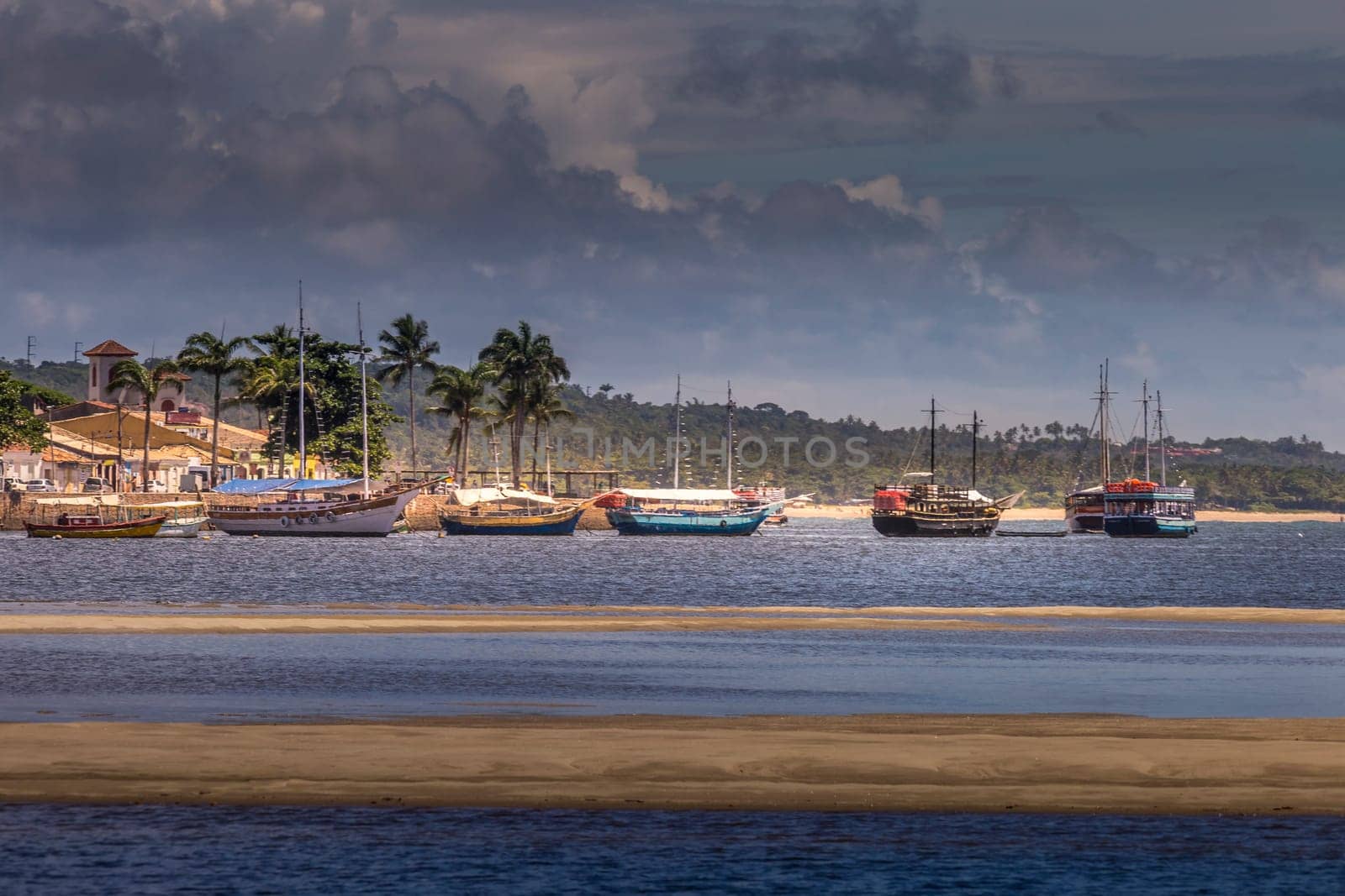 Idyllic Porto Seguro Beach at sunset with fishermen rustic wooden boats, BAHIA, Brazil