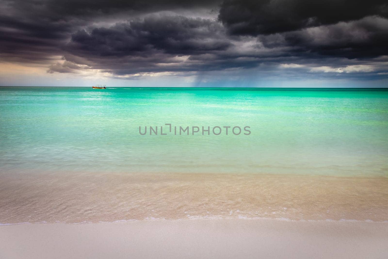 Tropical caribbean beach with storm clouds in idyllic Montego Bay, Jamaica