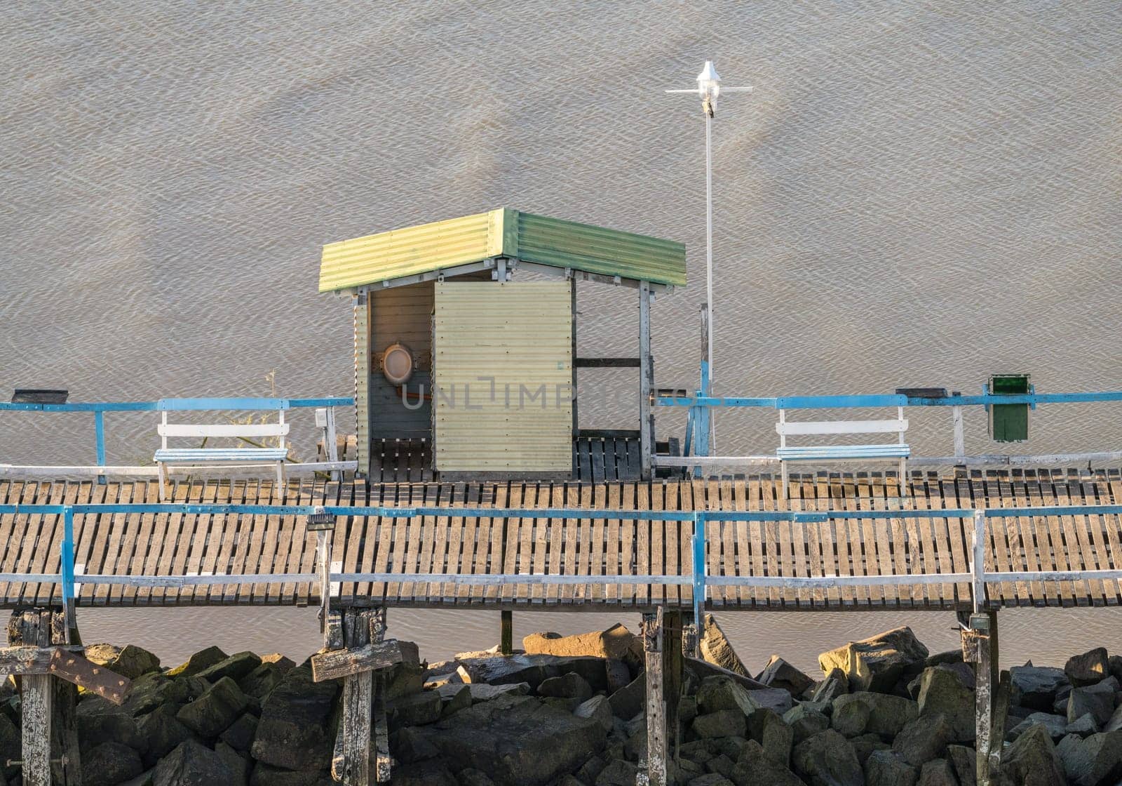Pier in the entrance to Buenos Aires harbor with male urinal in open shed