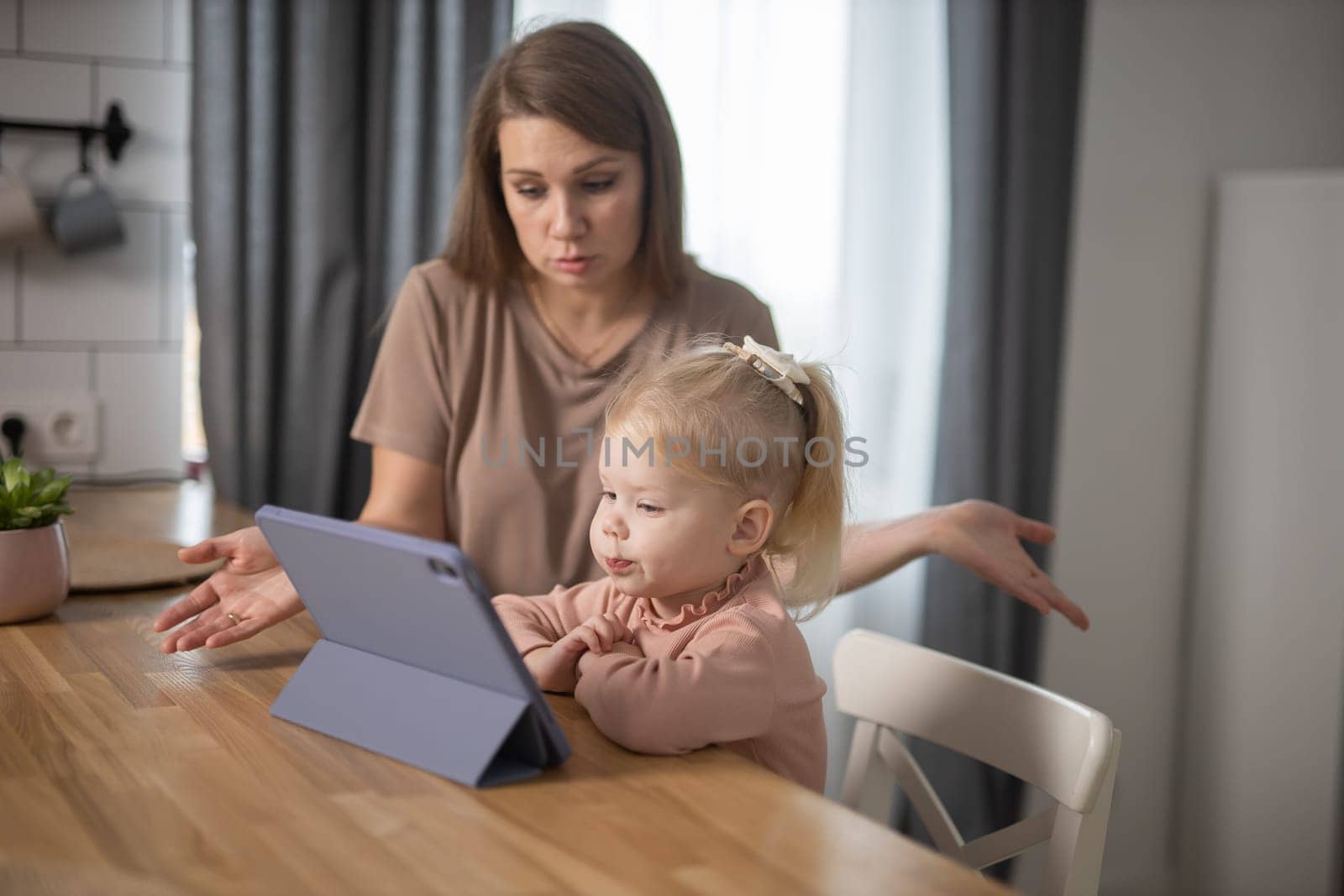 Deaf child girl with cochlear implant studying to hear sounds and have fun with mother - recovery after cochlear Implant surgery and rehabilitation concept by Satura86