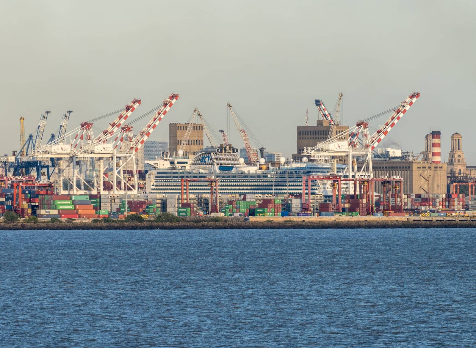 Buenos Aires, Argentina - 6 February 2023: Freight container cranes surround cruise ship in port