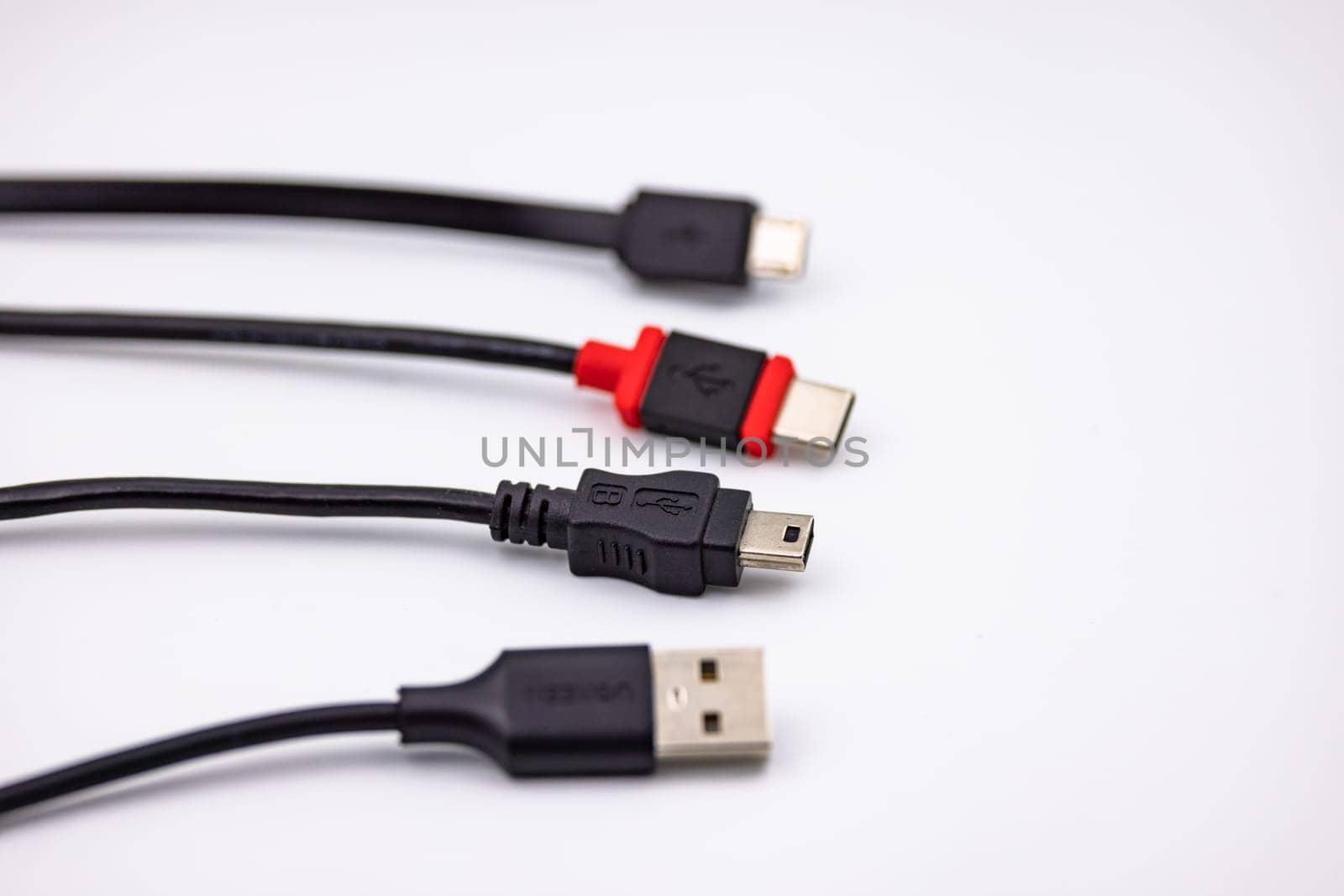 USB Type A and Type C as well as Micro USB and Mini USB connector cropped against white background with selective focus